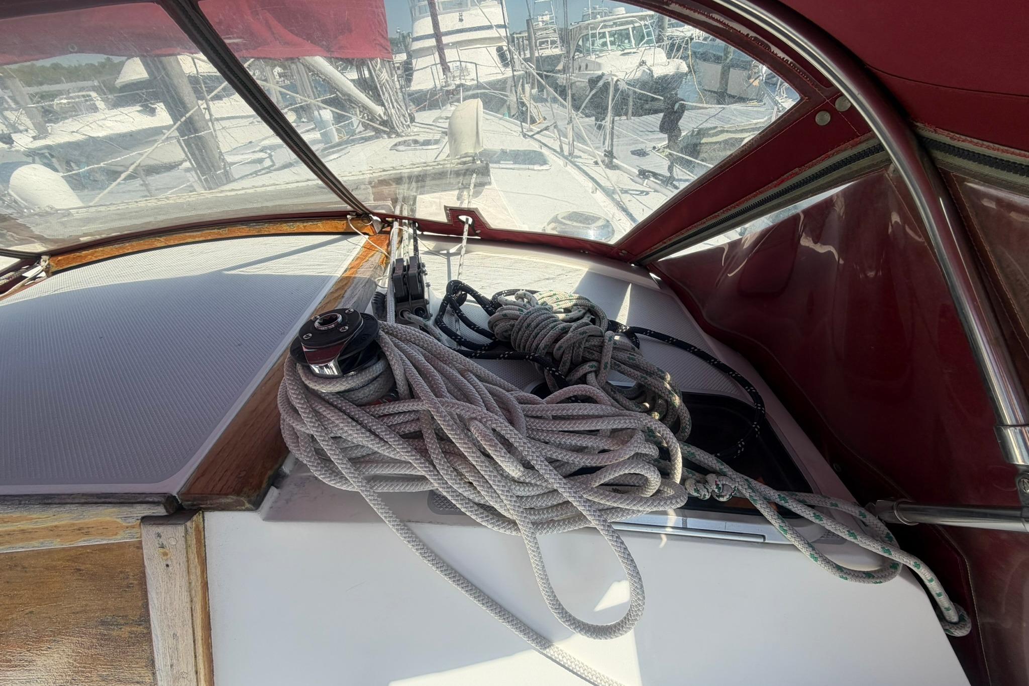 Cockpit view of a 1993 Catalina 42 sailboat with ropes and winch.
