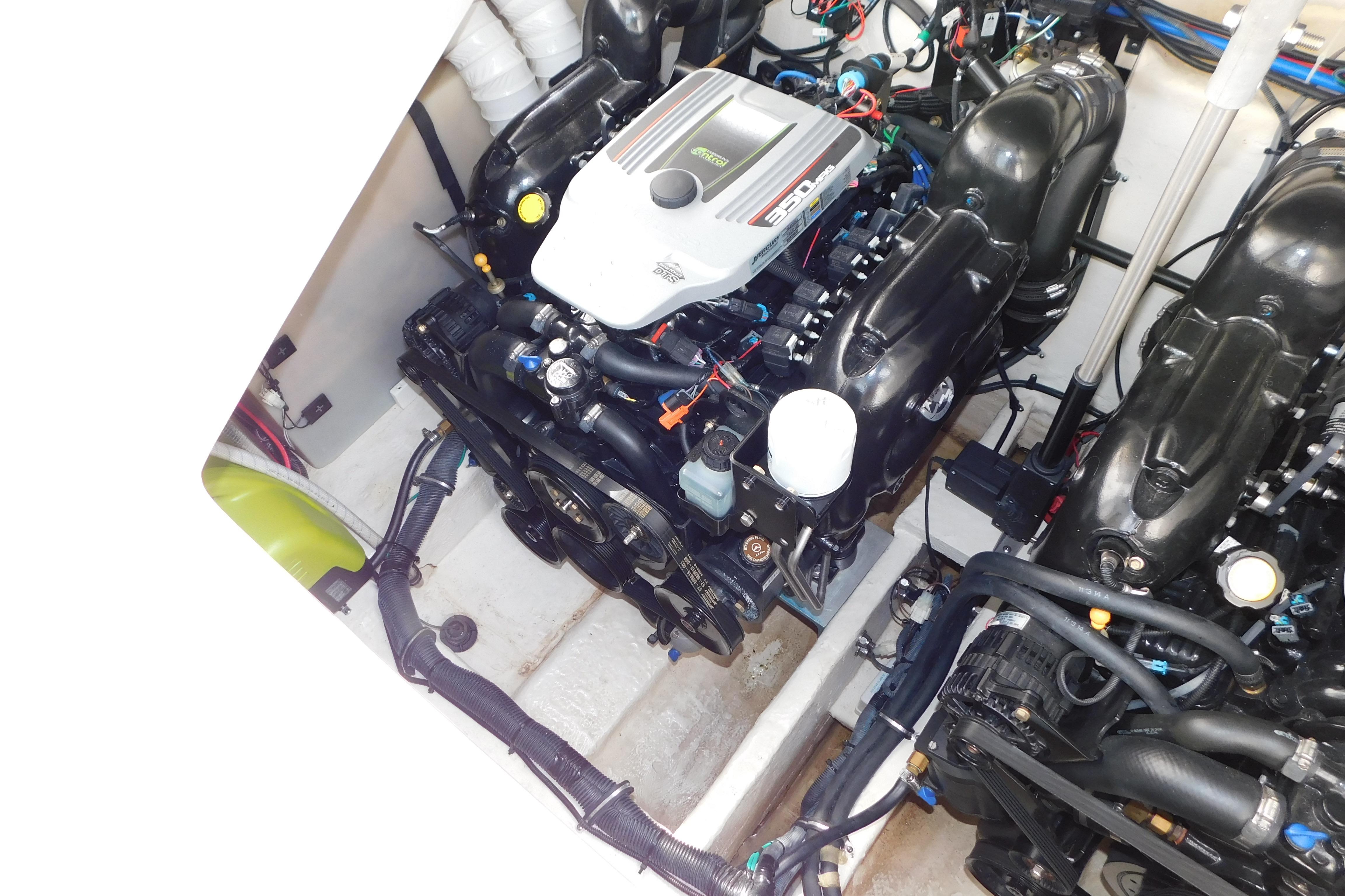 Engine compartment of a 2017 Rinker EX 320 boat, showcasing dual engines and components.