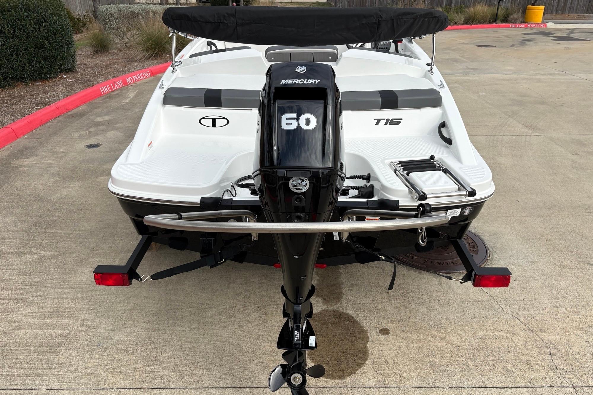 2025 Tahoe T16 boat with Mercury 60 outboard motor, parked on concrete.