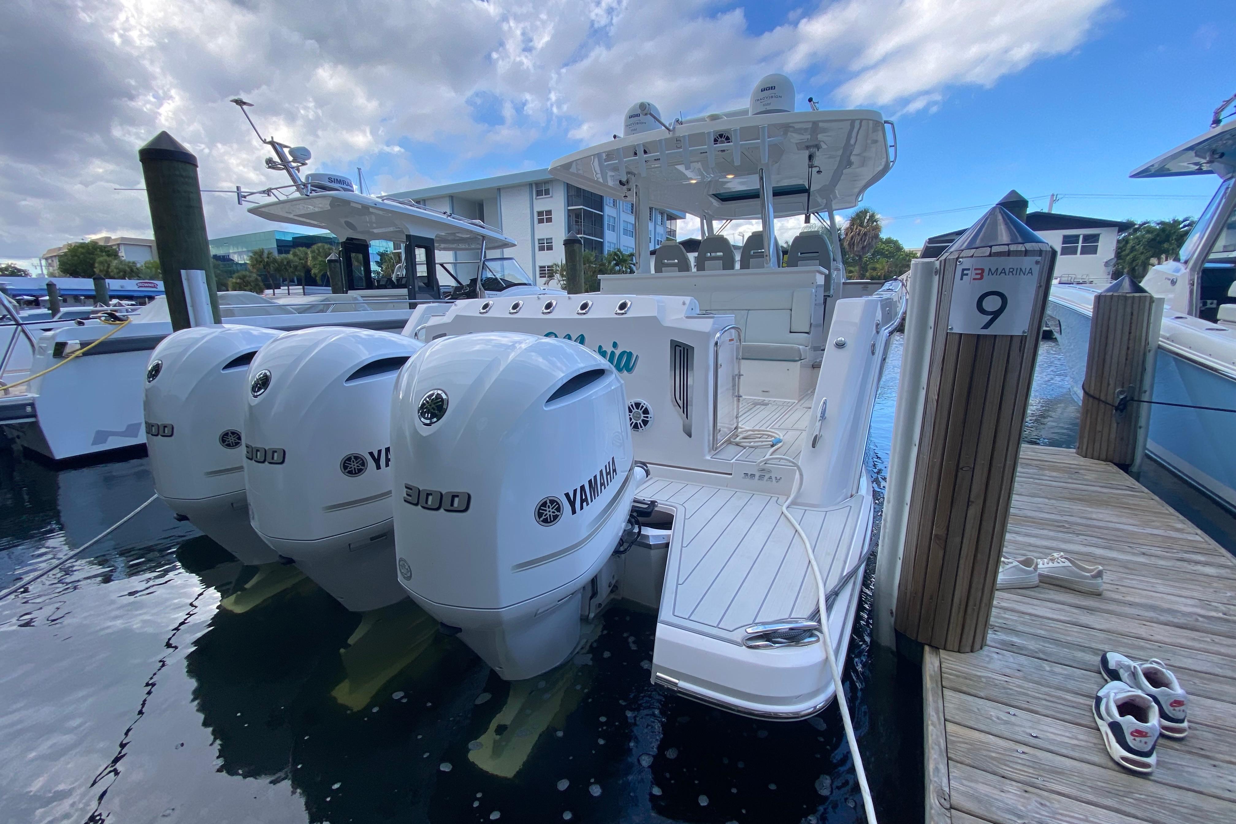 2021 Regal 38 SAV boat docked with Yamaha engines at marina.