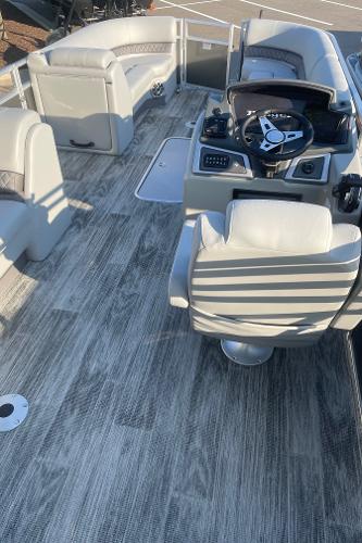 2024 Ranger Reata 223C boat interior with modern seating and steering console.