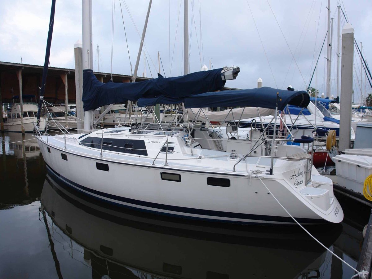 1995 Hunter 36 Vision sailboat docked in marina.