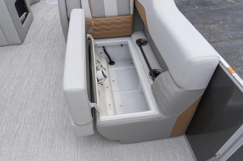 2026 SunCatcher Elite 326 SS boat interior with open storage compartment and cup holders.