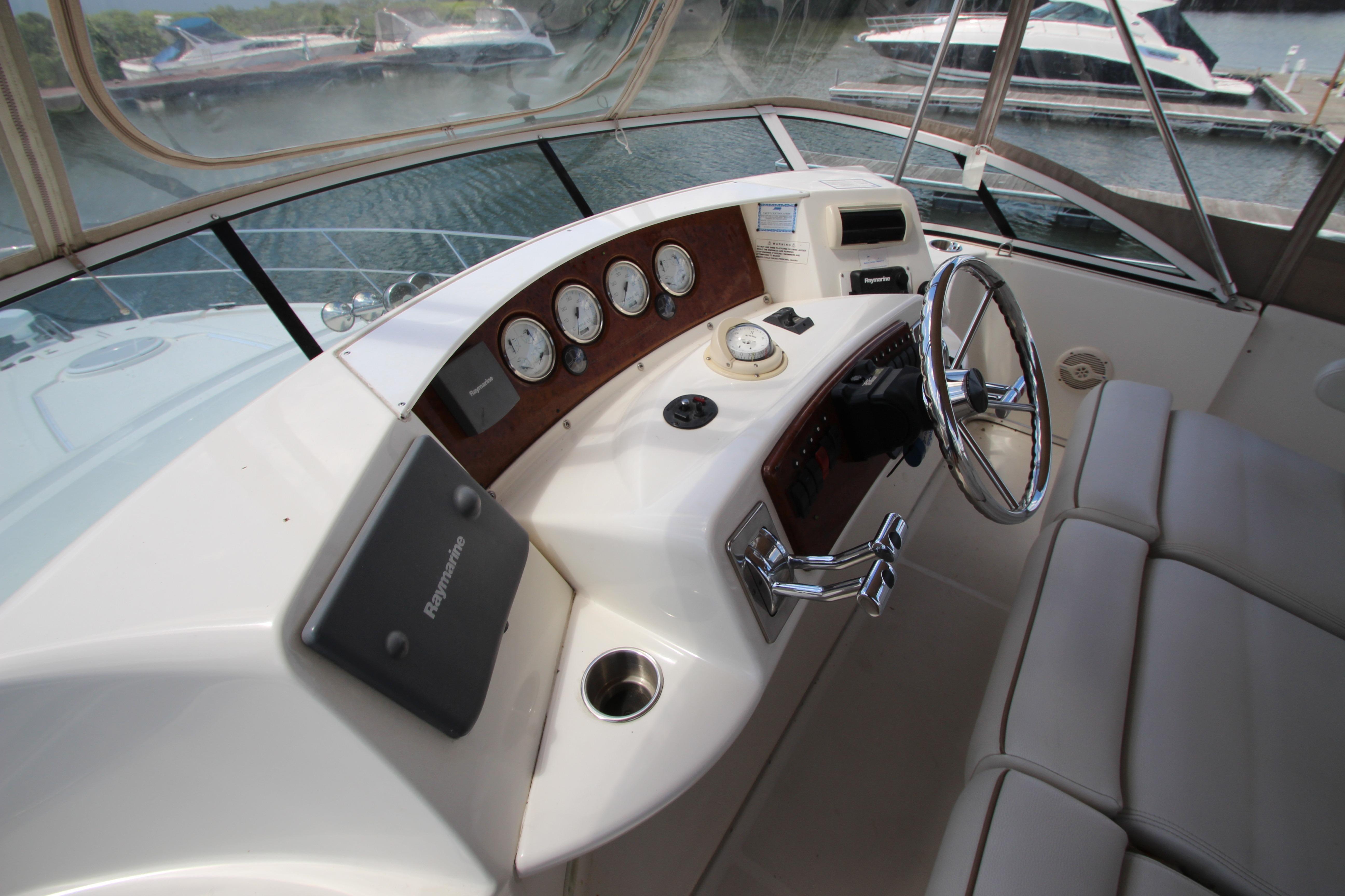 Helm of 2006 Silverton 38 Sport Bridge yacht with steering wheel and navigation instruments.
