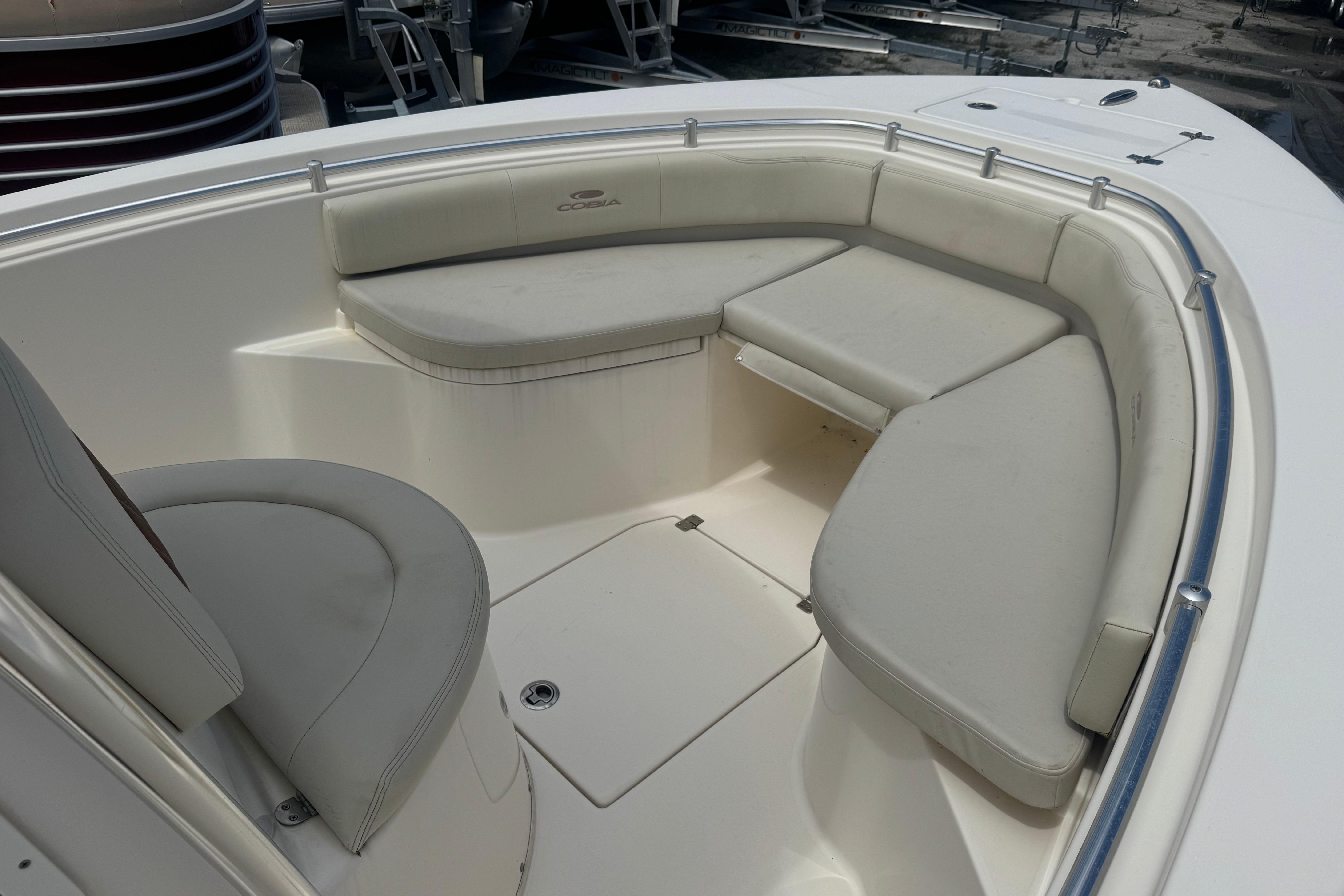 2022 Cobia 237 Center Console boat with cushioned seating area.