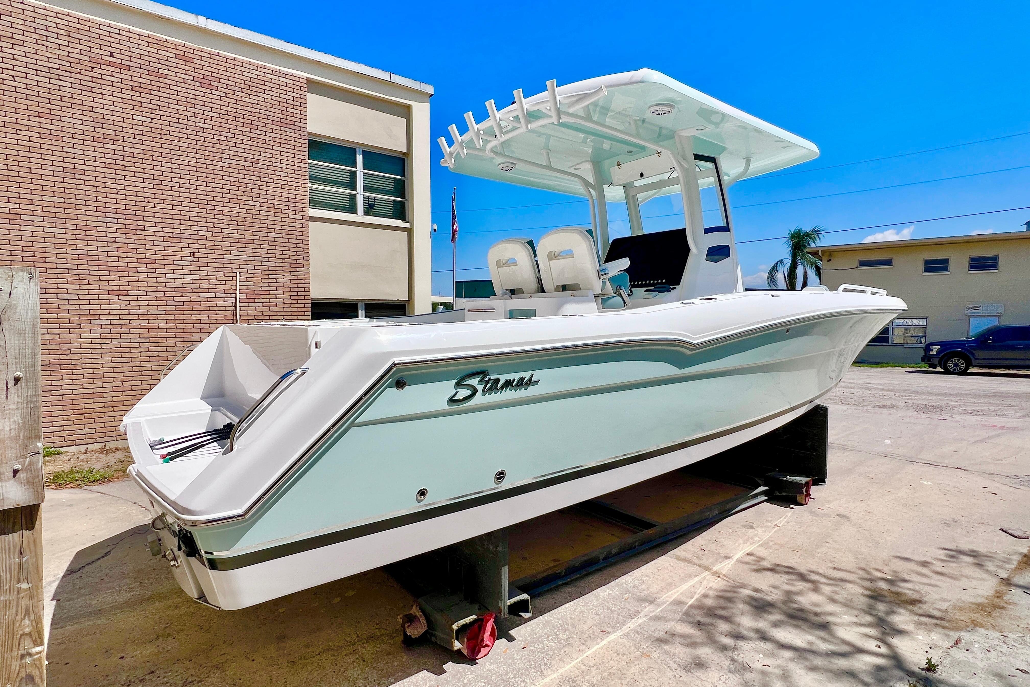 2026 Stamas 31T Aventura boat with sleek design, parked outdoors under clear blue sky.