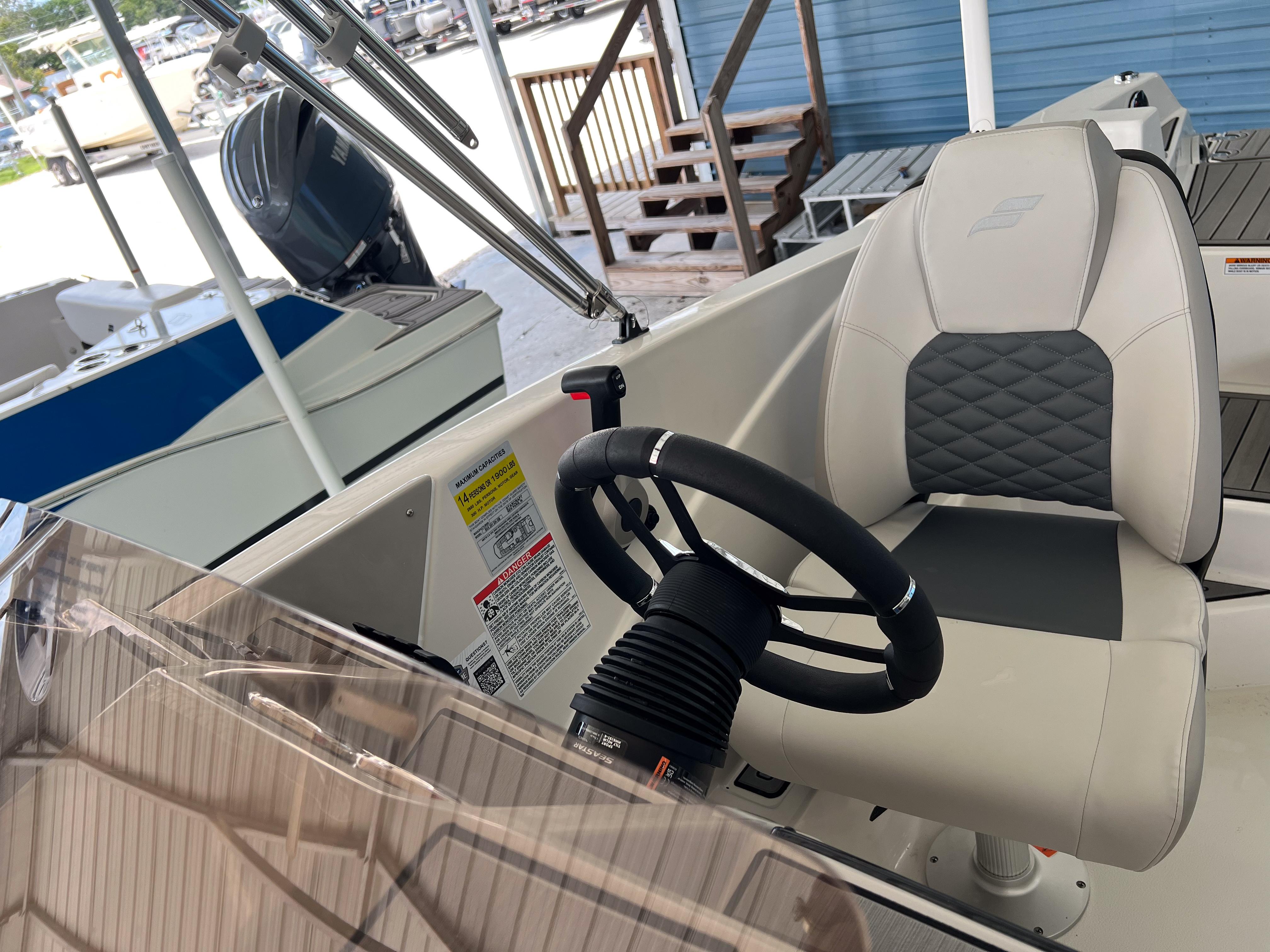 2026 Starcraft SVX 231 OB boat interior with steering wheel and captain's chair.