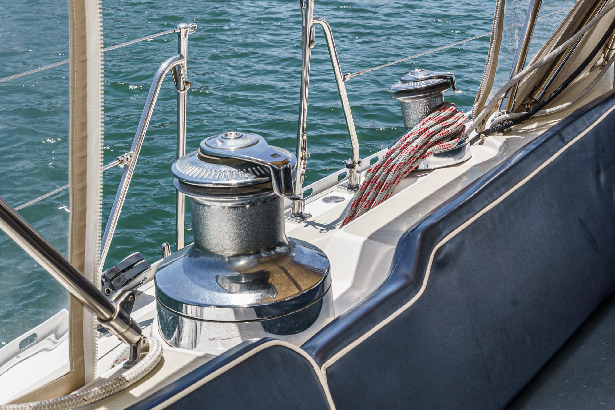 Deck of 2001 Hylas 49 sailboat with winches and ropes by the water.
