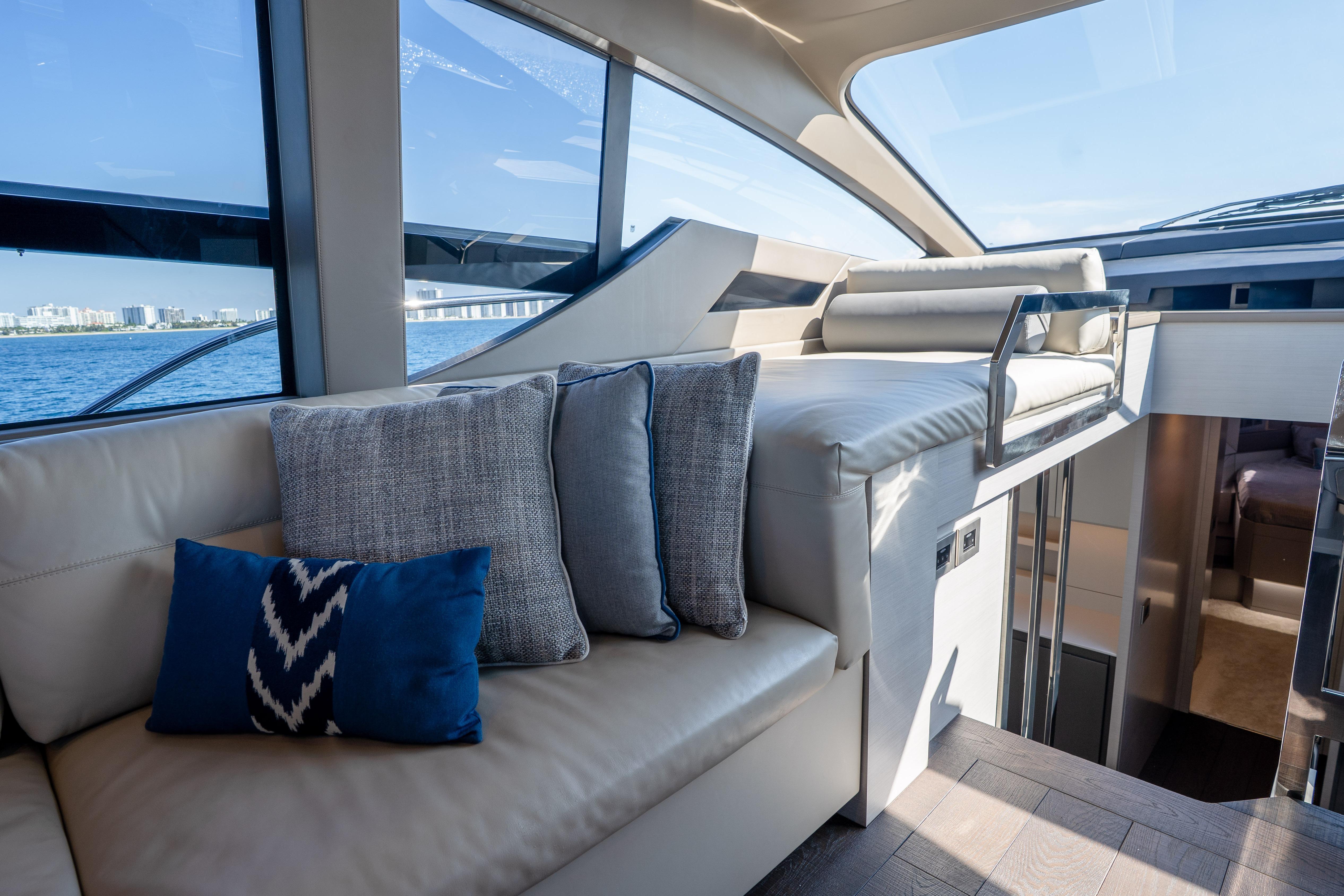 Luxurious interior of 2024 Pershing 7X yacht with elegant seating and ocean view.