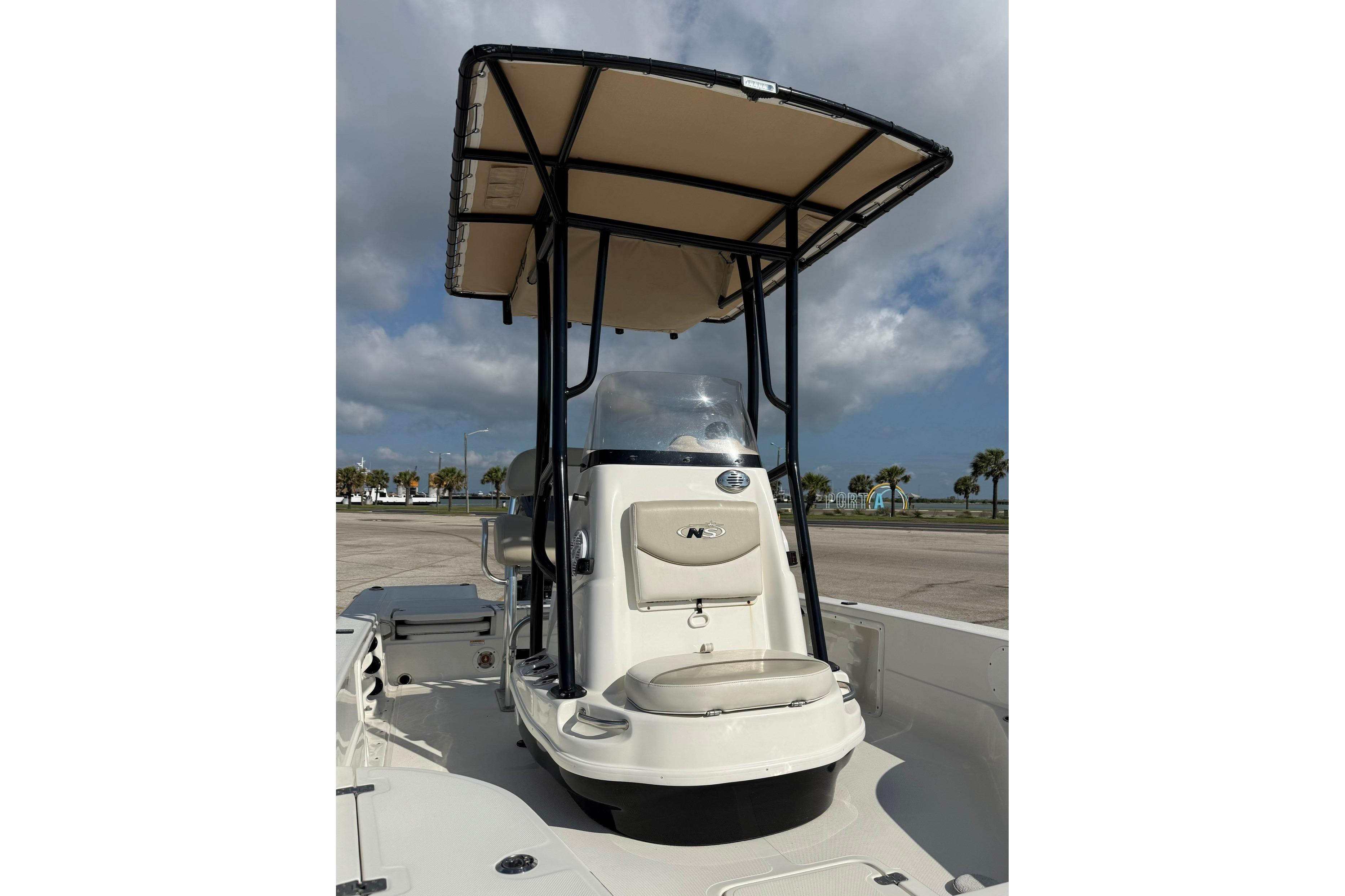2015 NauticStar 224 XTS boat with T-top, parked on a sunny day.