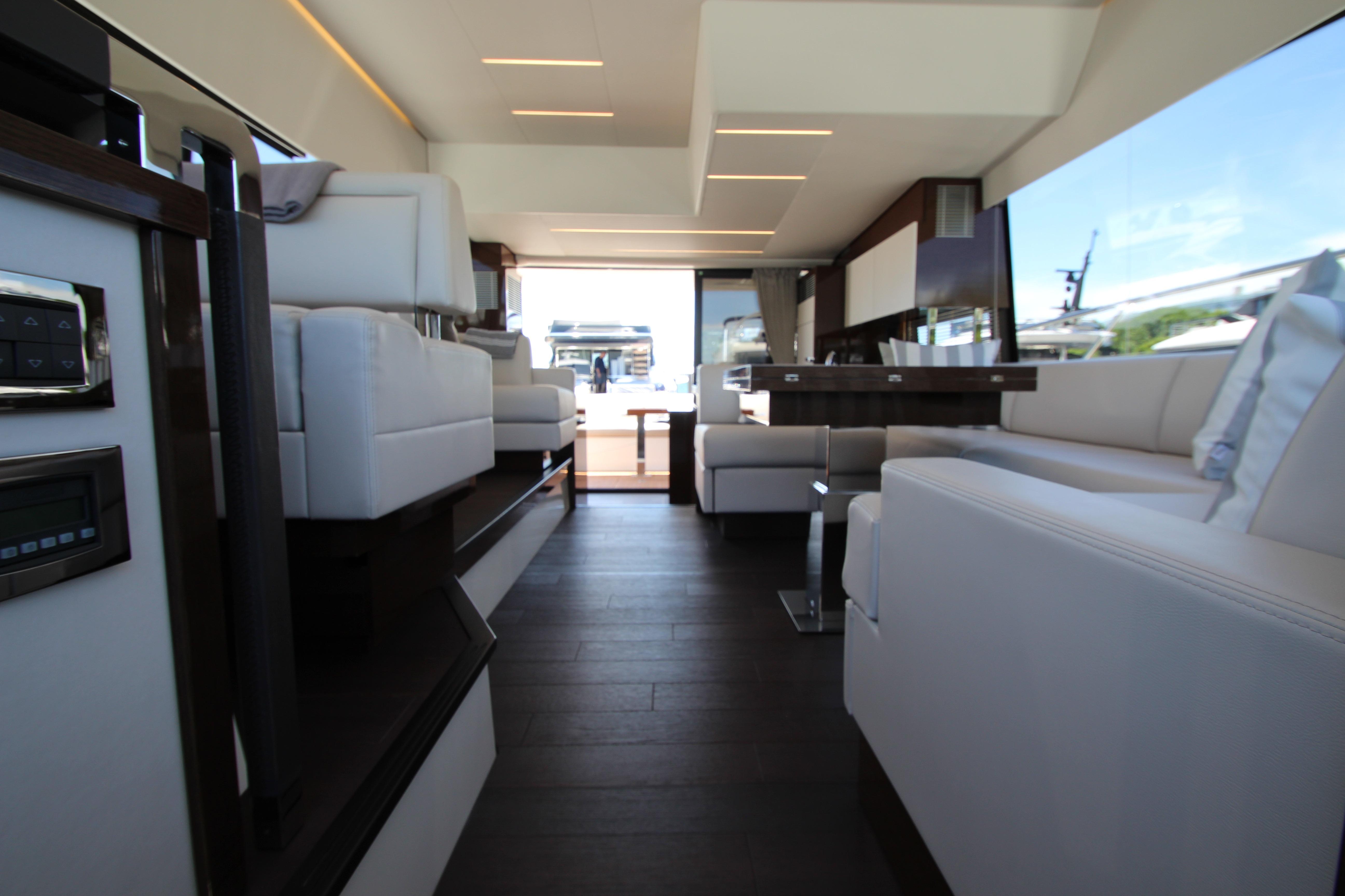 Luxurious interior of a 2022 Prestige 520 yacht with modern seating and sleek design.