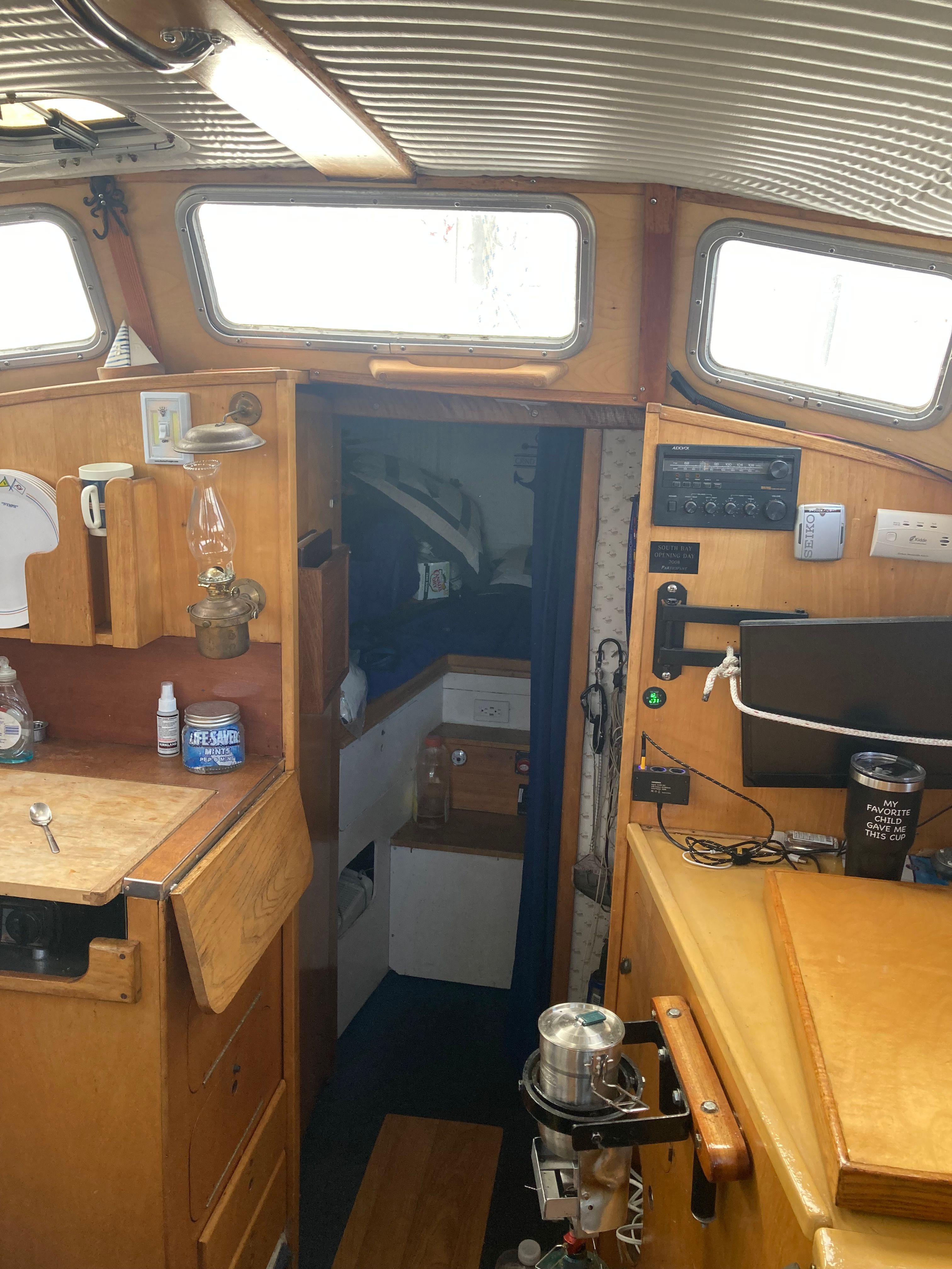 Interior of a 1969 Alberg Oceana yacht with wooden furnishings.