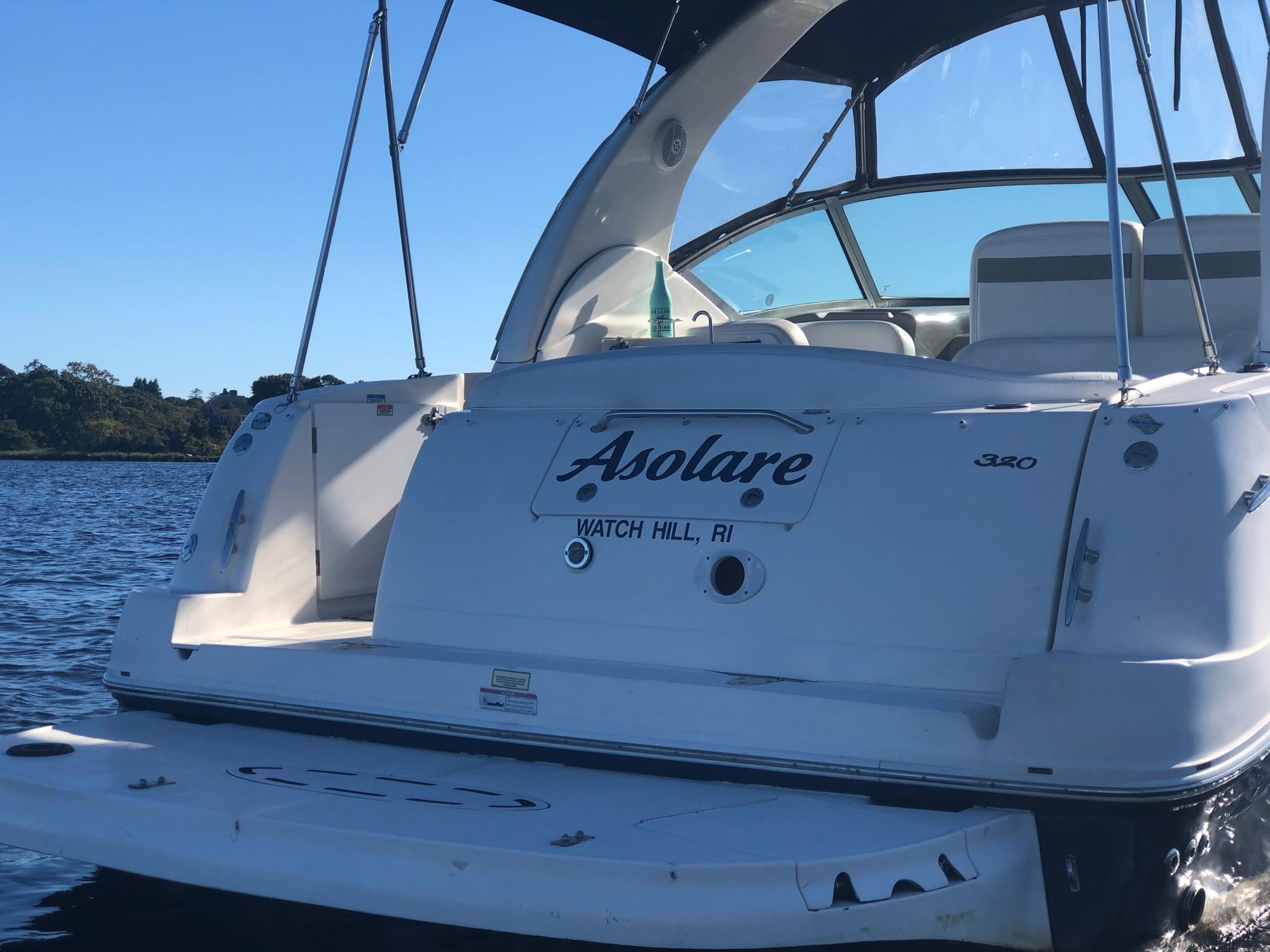 2006 Sea Ray 320 Sundancer boat on water, rear view, with "Asolare" name.
