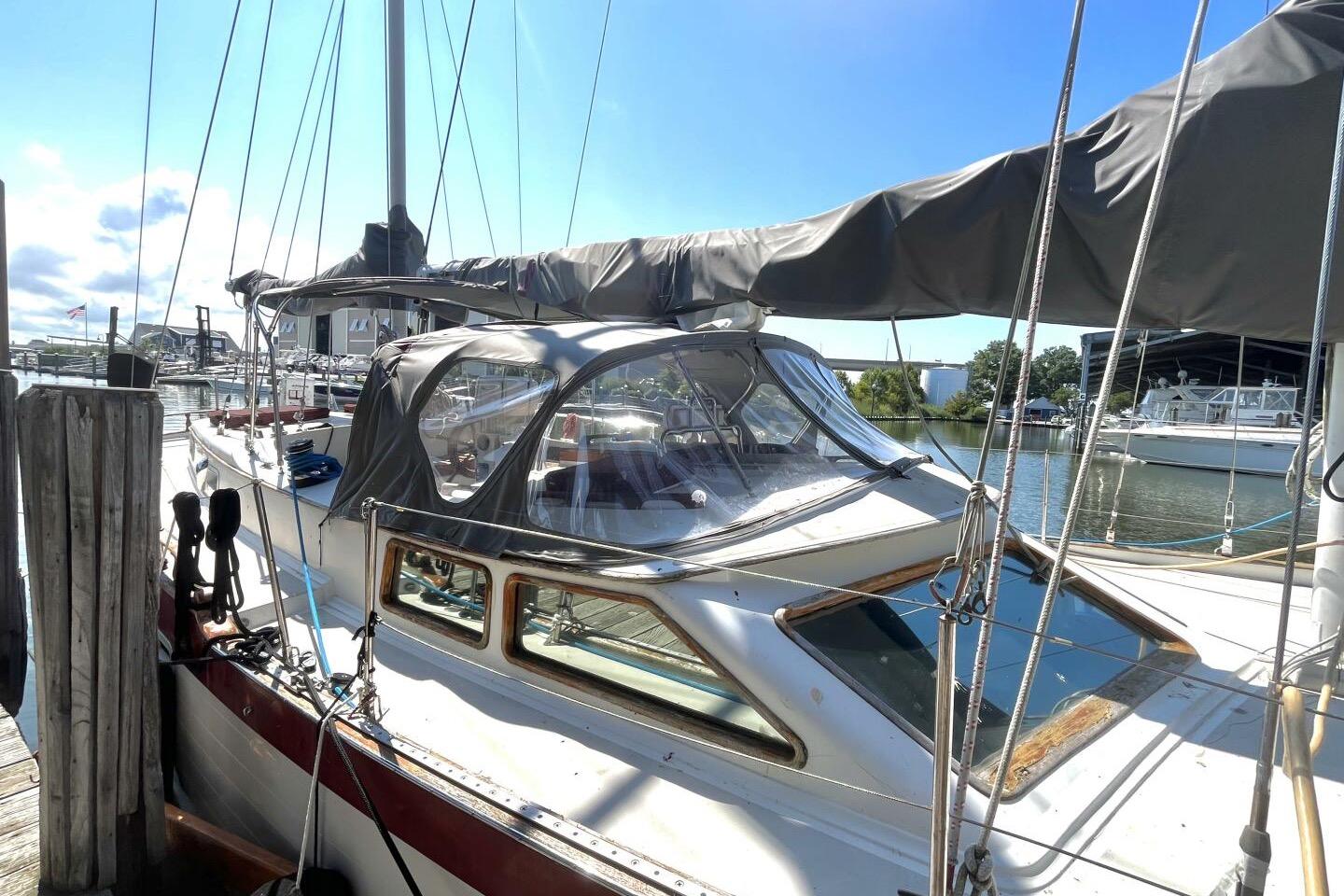 1979 Hardin 44 sailboat docked at marina under clear blue sky.