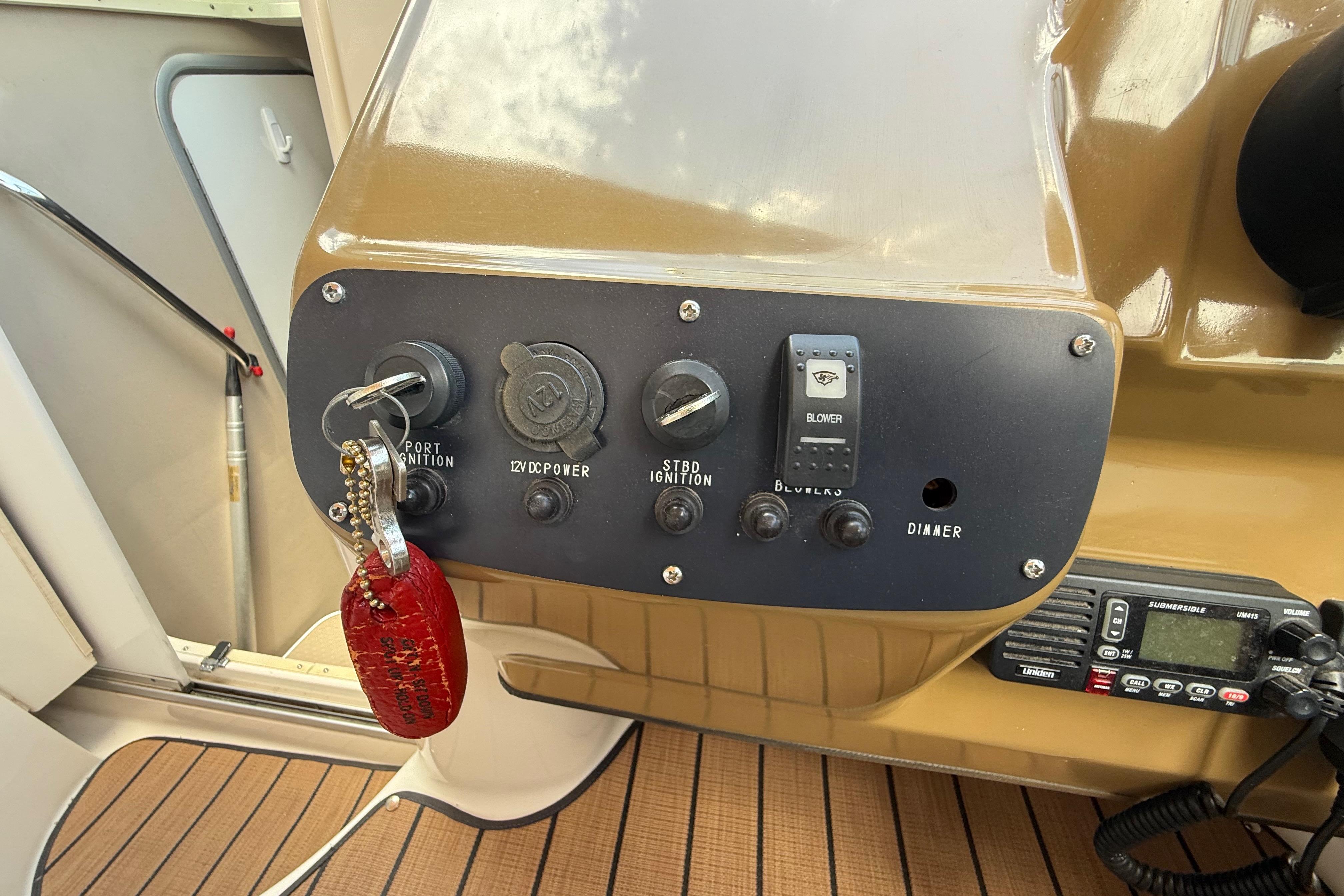 Control panel of a 1999 Chaparral Signature 300 boat with ignition keys and switches.