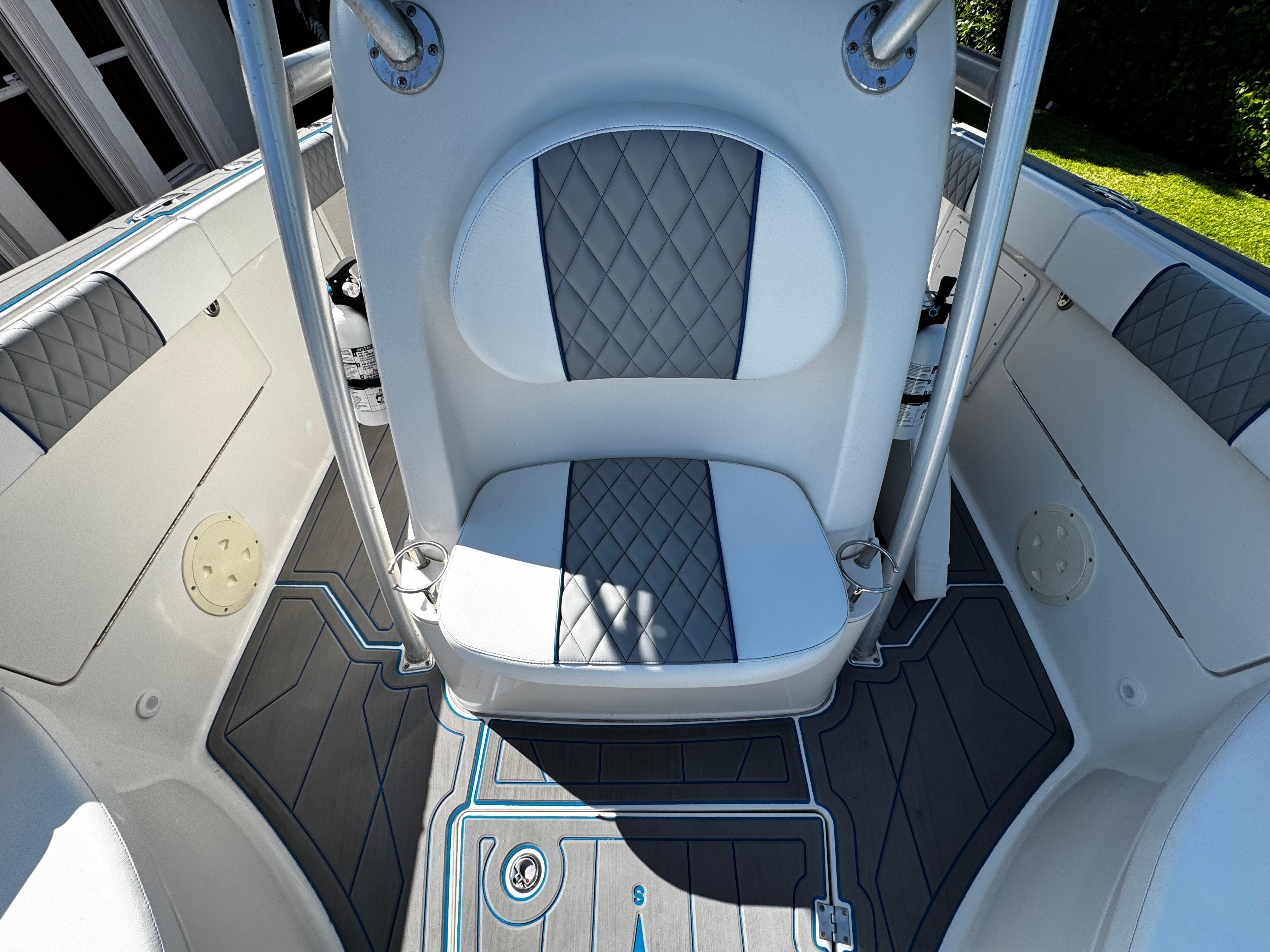 2004 Robalo R 260 boat interior with gray and white seating and flooring.