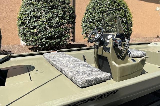 2026 Tracker Grizzly 1860 CC boat with camouflage seating and steering console.