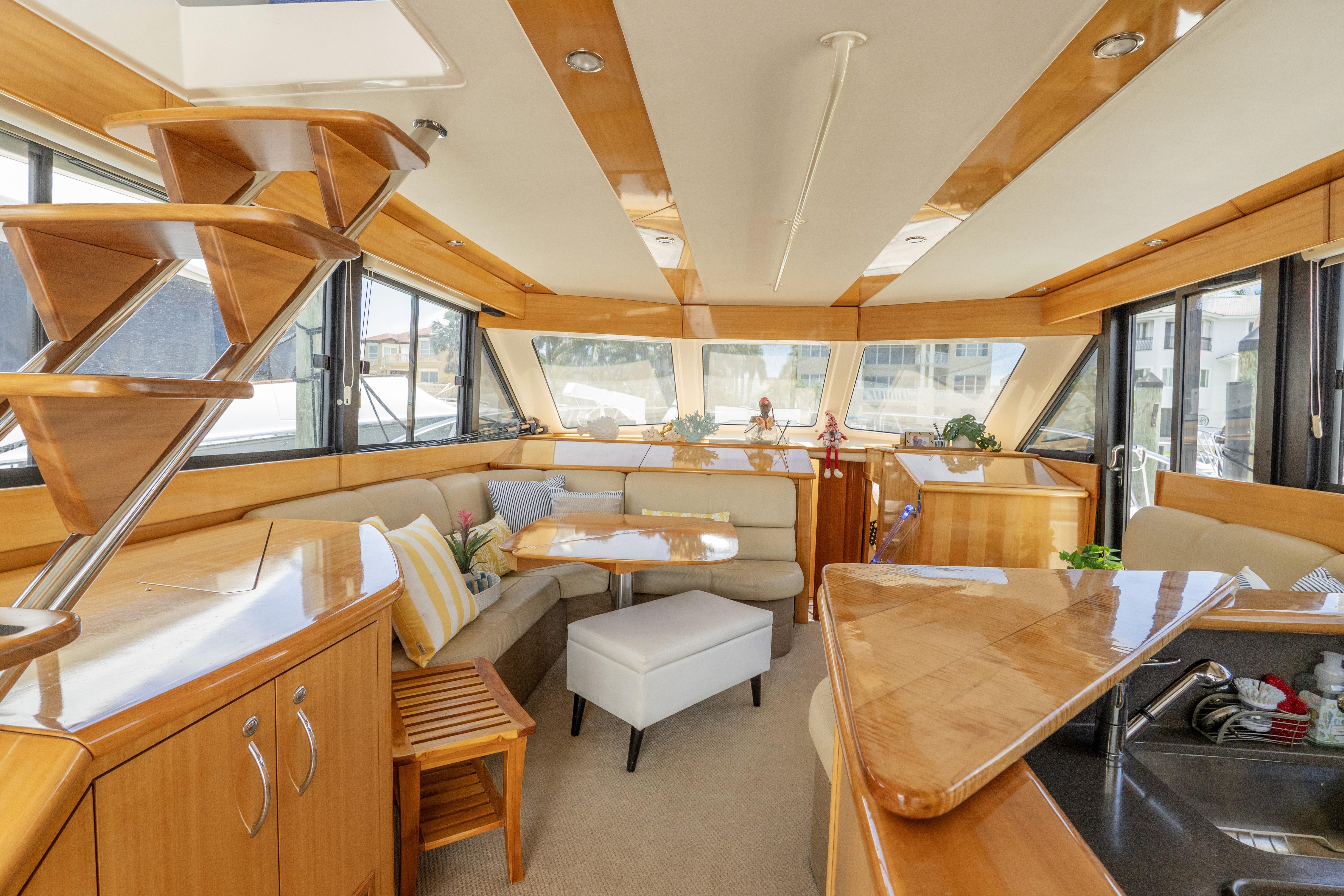 Luxurious interior of a 2008 Maritimo 52 yacht with elegant wood finishes and spacious seating.