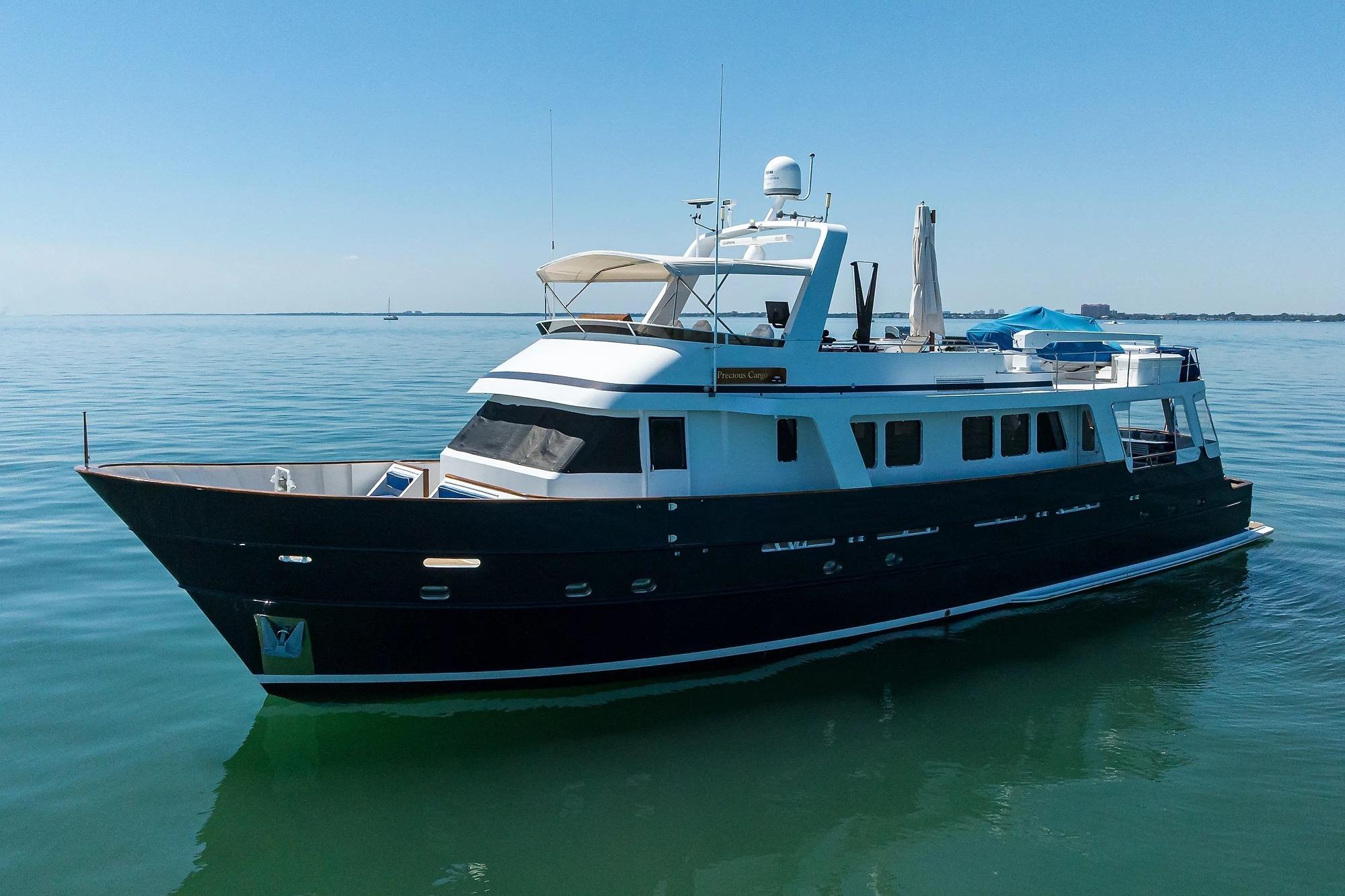 1986 Jongert 85 yacht on calm water under clear blue sky.