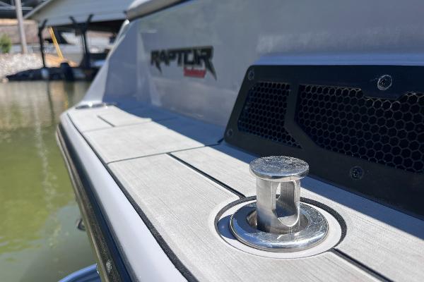 2024 Moomba Max boat with Raptor engine detail, docked on calm water.