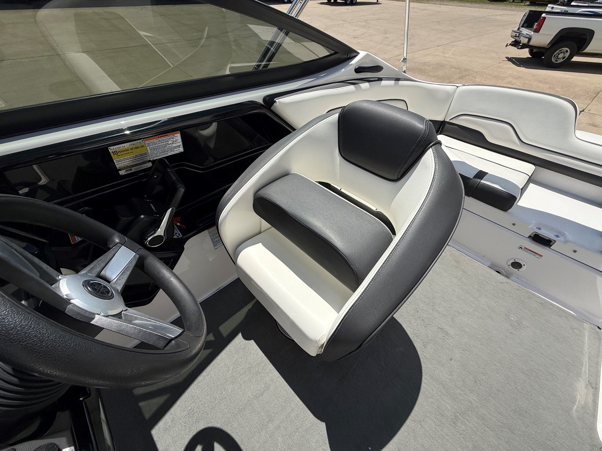 Interior of a Yamaha SX210 boat with a swivel seat and steering wheel.