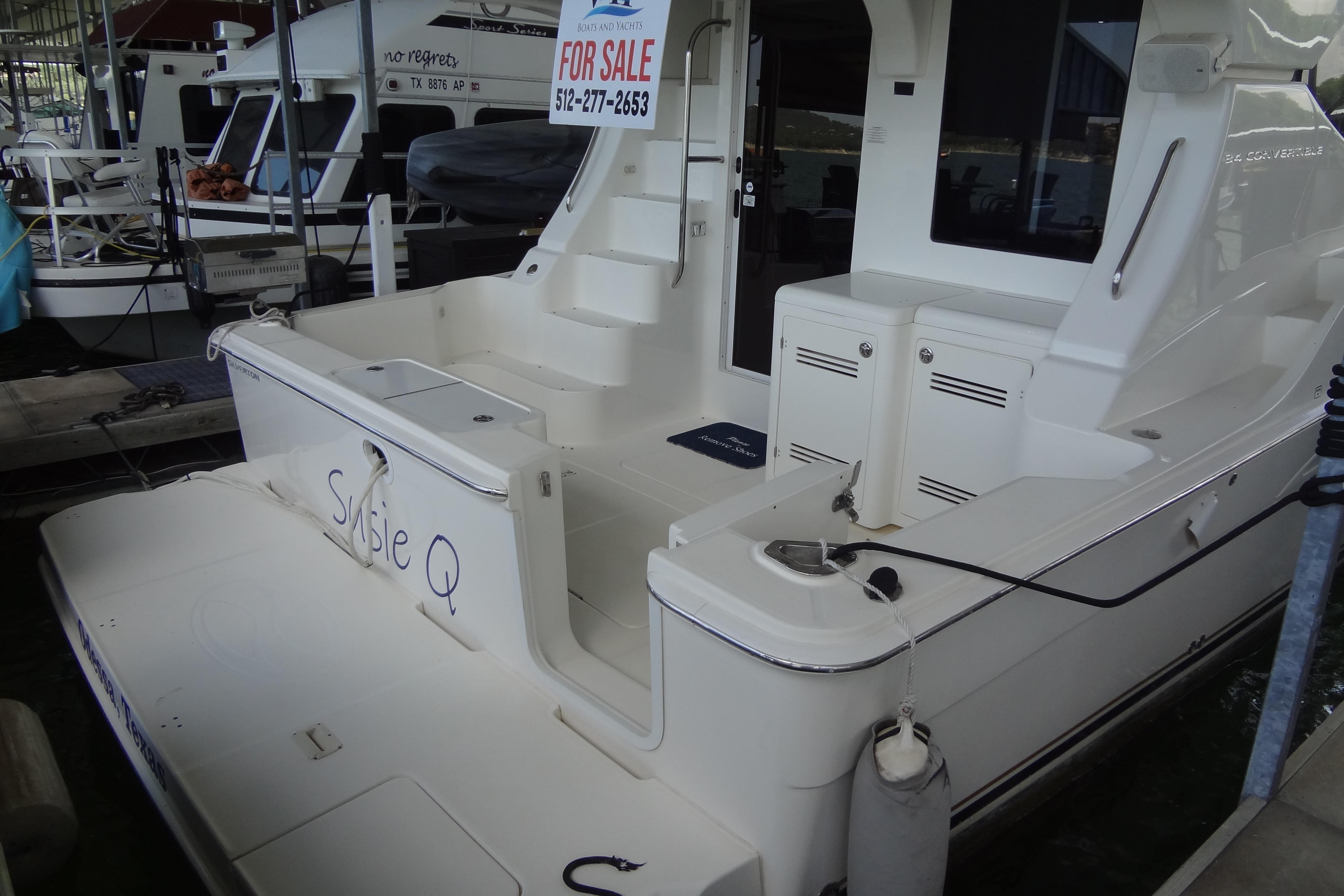 2005 Silverton 34 Convertible yacht for sale, docked with visible "For Sale" sign.