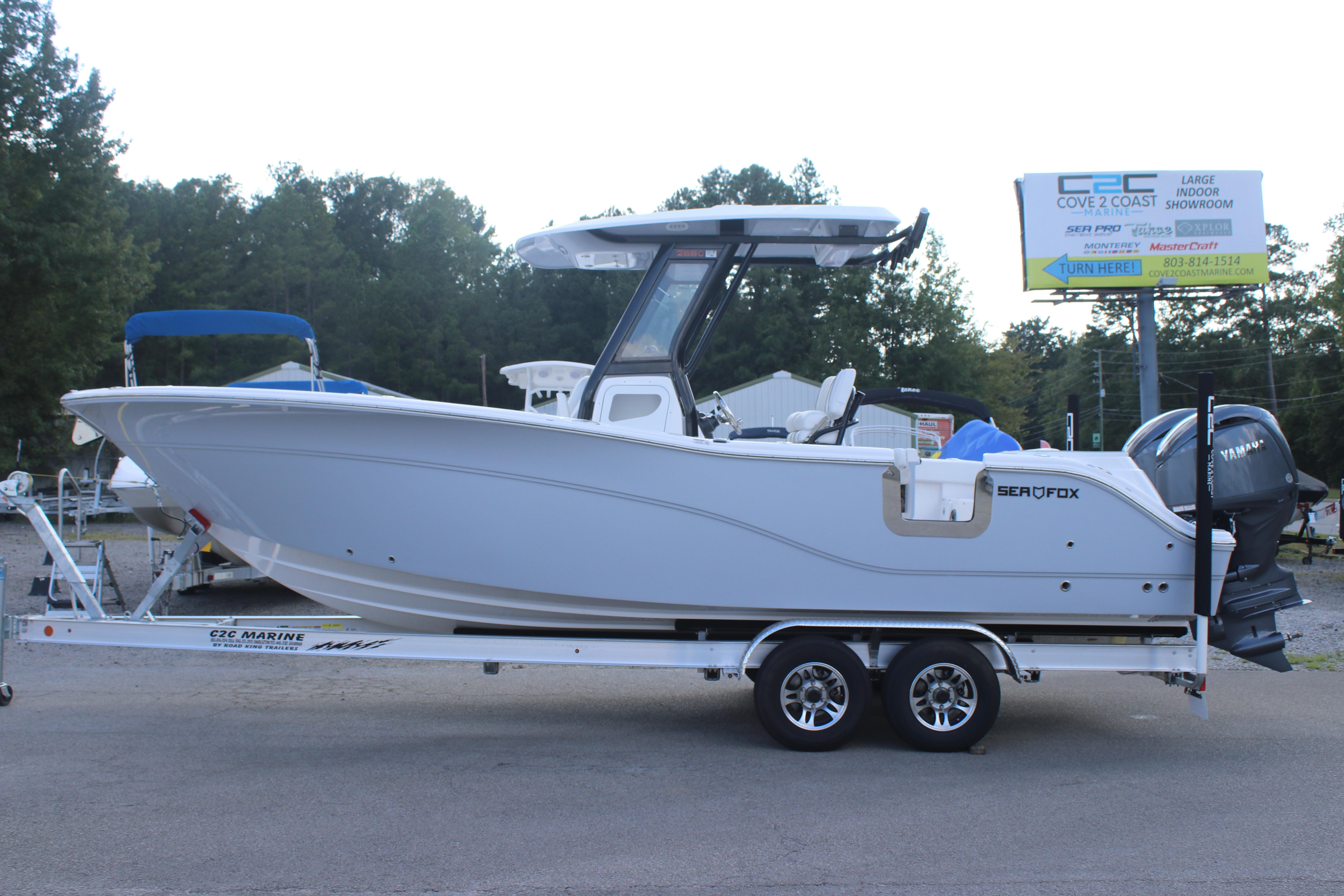 2026 Sea Fox 268 Commander boat on trailer, side view, outdoor showroom setting.
