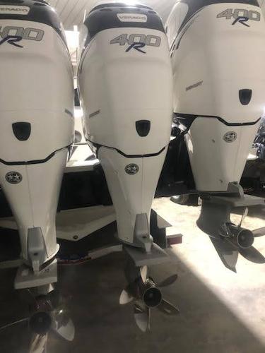 2019 Midnight Express 39 Cuddy with triple 400R outboard engines in a garage.