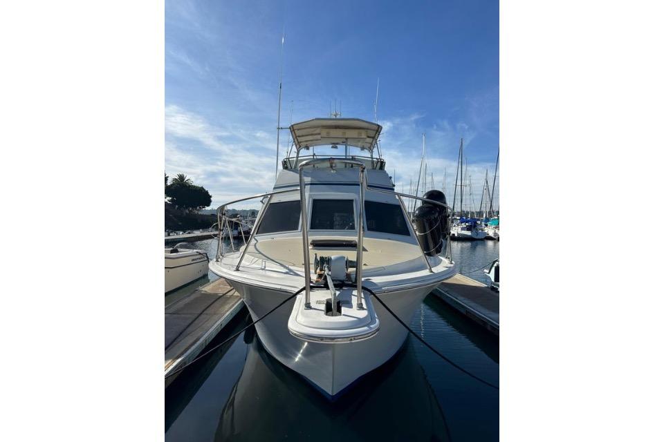 1985 Egg Harbor 33 Sedan yacht docked at marina under clear blue sky.
