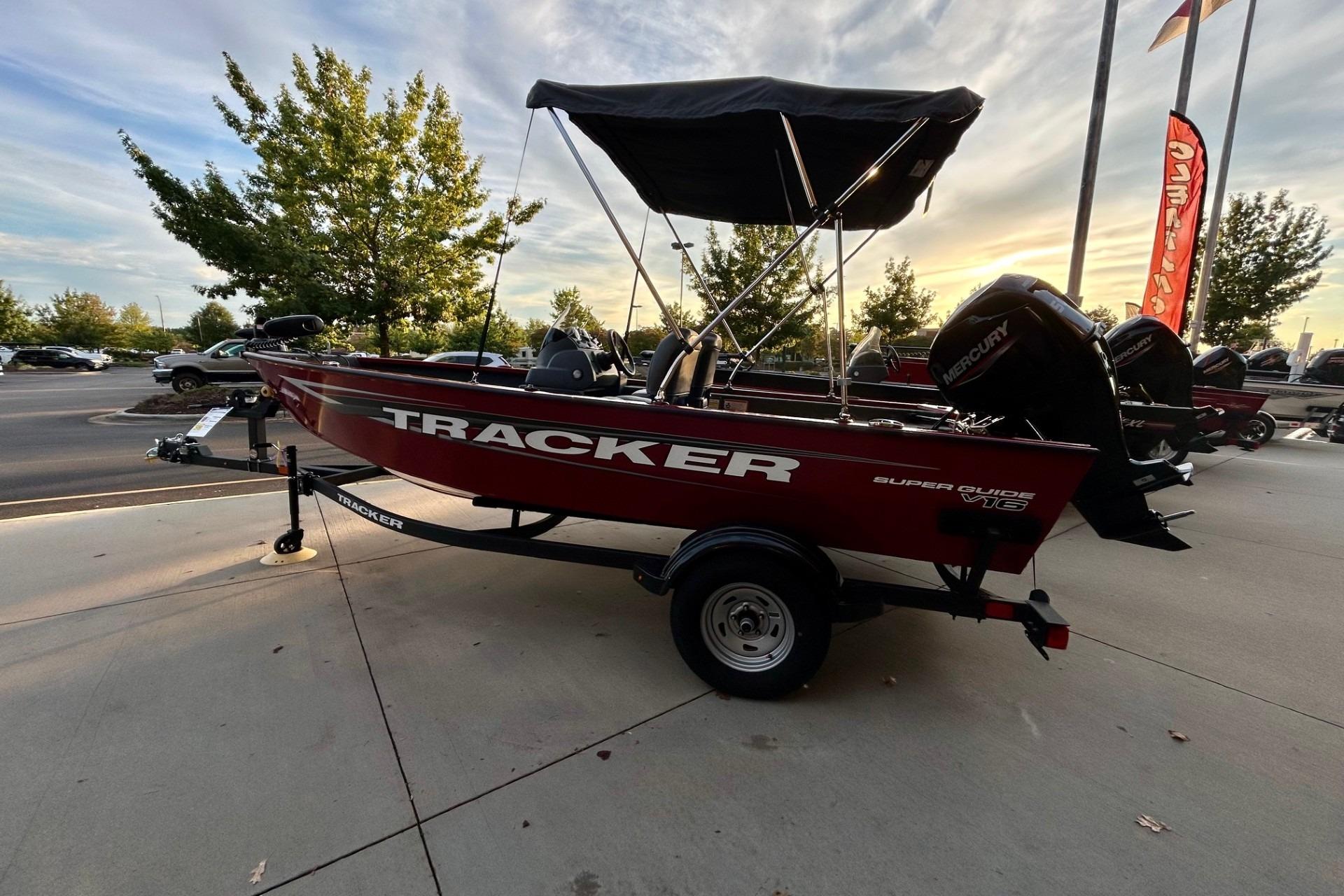 2026 Tracker Super Guide V-16 SC boat on trailer, parked outdoors at sunset.
