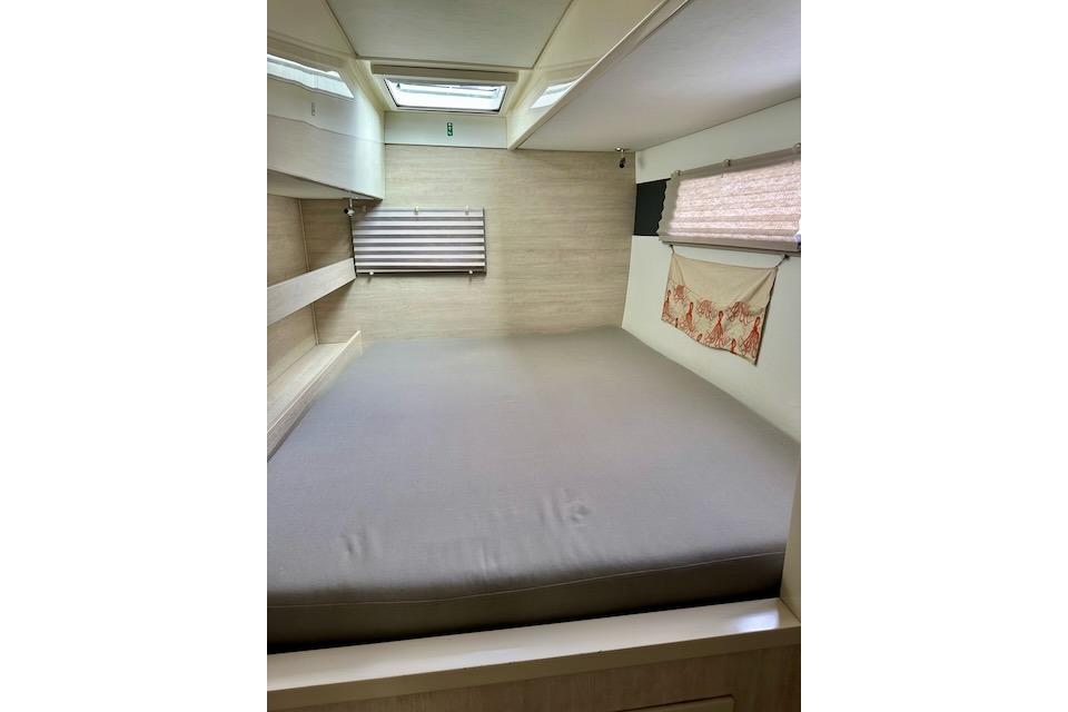 Interior cabin of a 2017 Leopard 40 catamaran with a cozy bed and skylight.