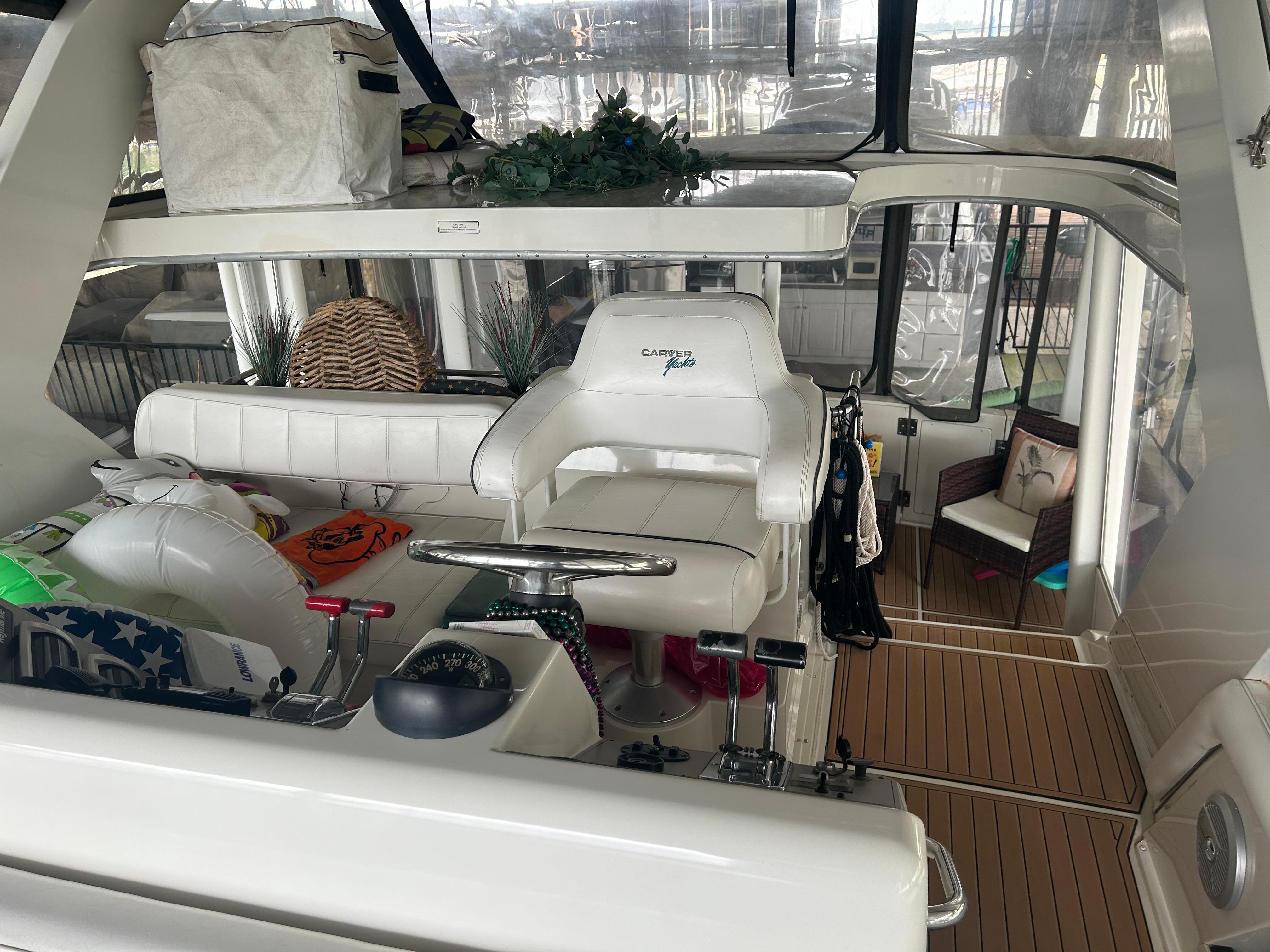 1996 Carver 440 Aft Cabin Motor Yacht interior with helm and seating area.