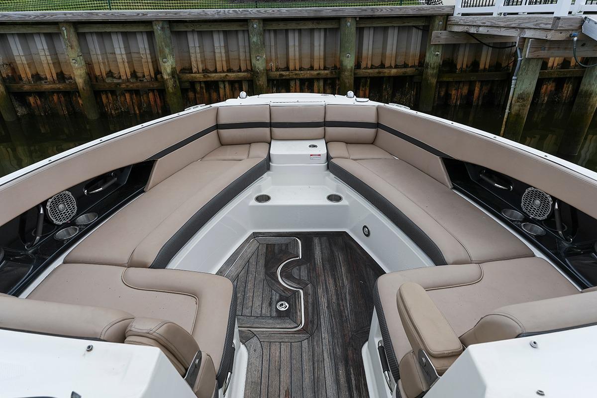 2018 Sea Ray SLX 350 boat interior with spacious seating and wood flooring.