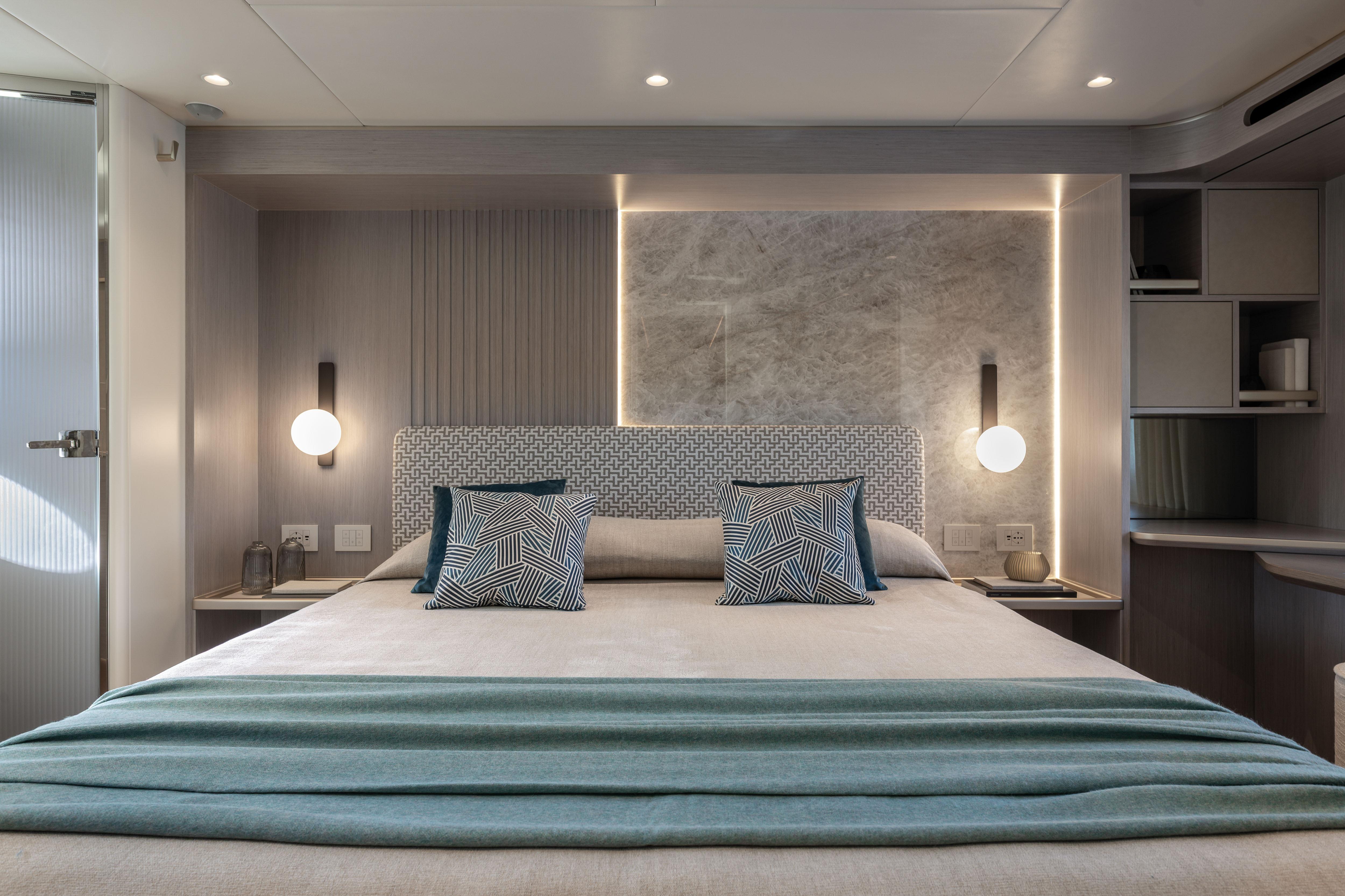 Elegant bedroom on a yacht with modern design and soft lighting.