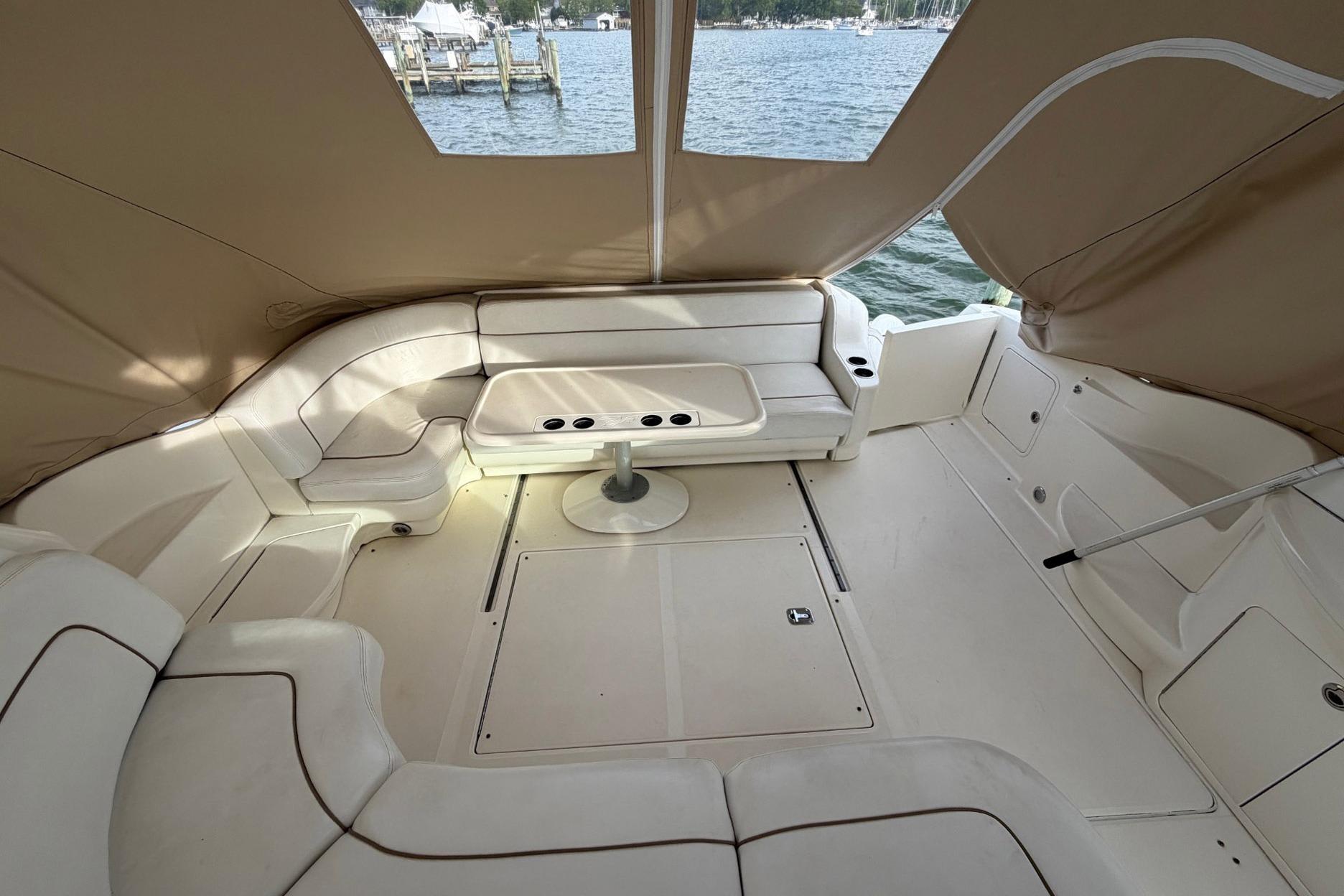 Spacious interior of 2000 Sea Ray Sundancer 460 yacht with comfortable seating and table.