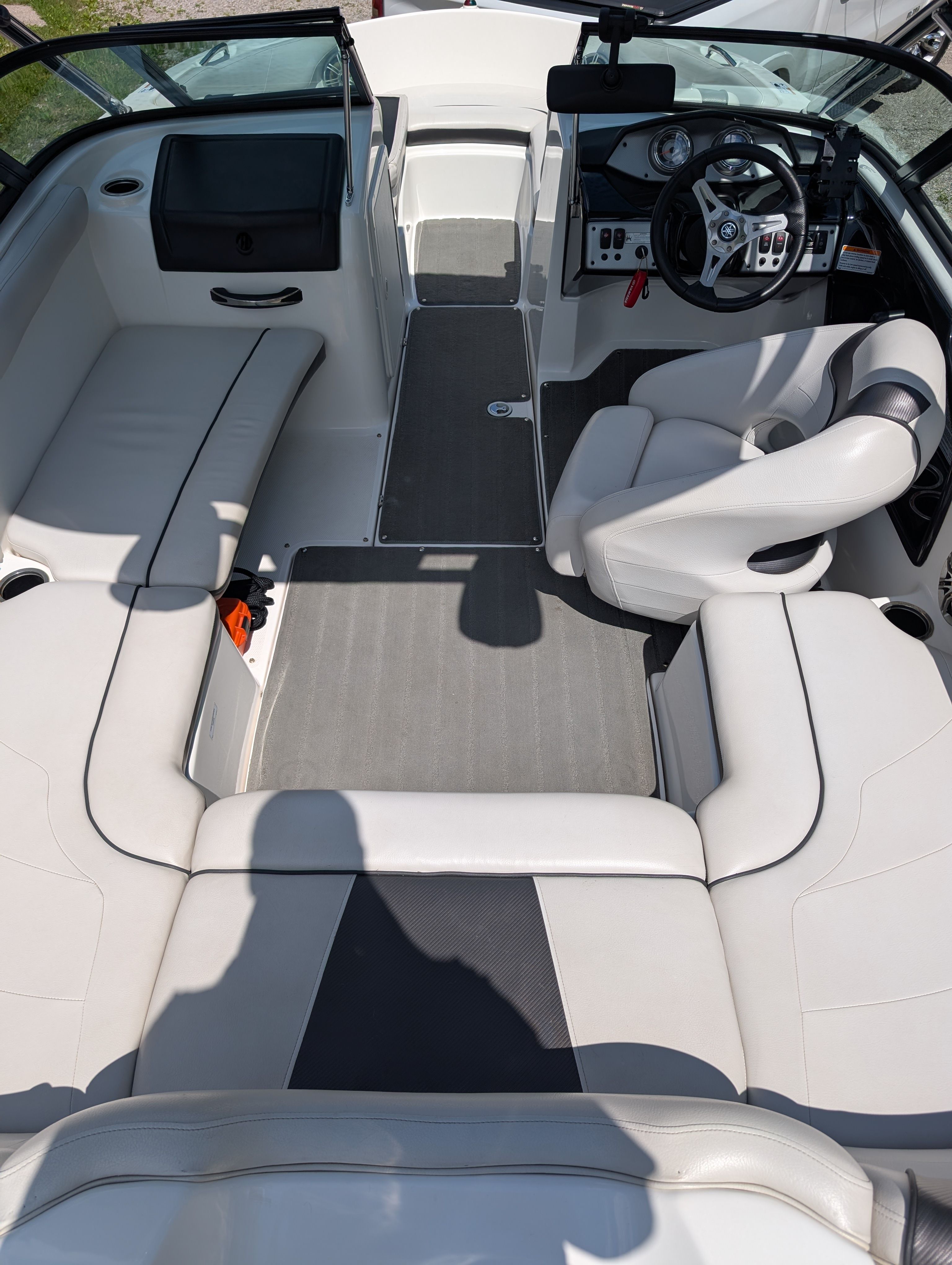 Interior view of a 2014 Yamaha AR192 boat with white seating and gray flooring.