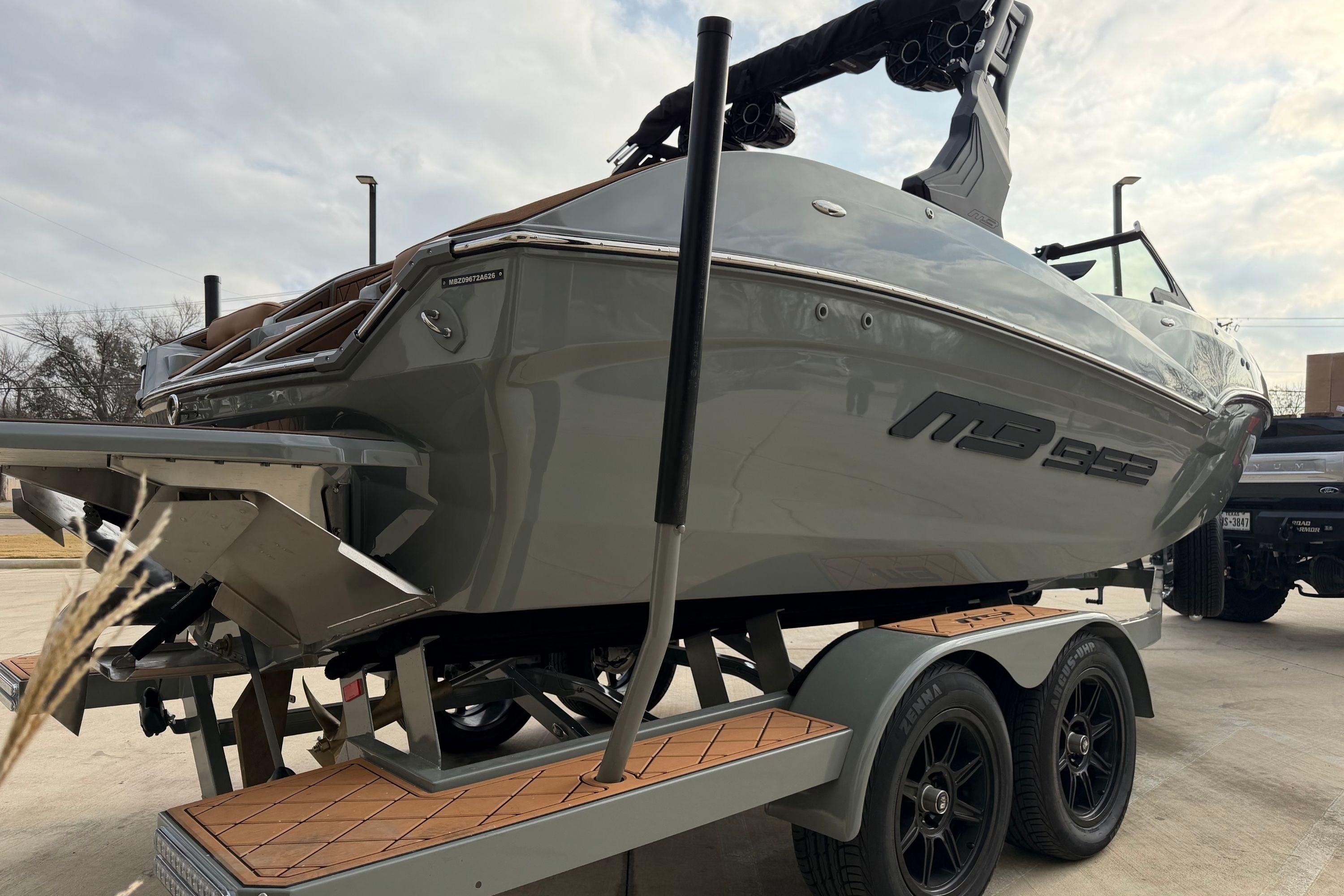 2026 MB B52 21 Alpha boat on trailer, sleek design, parked outdoors.
