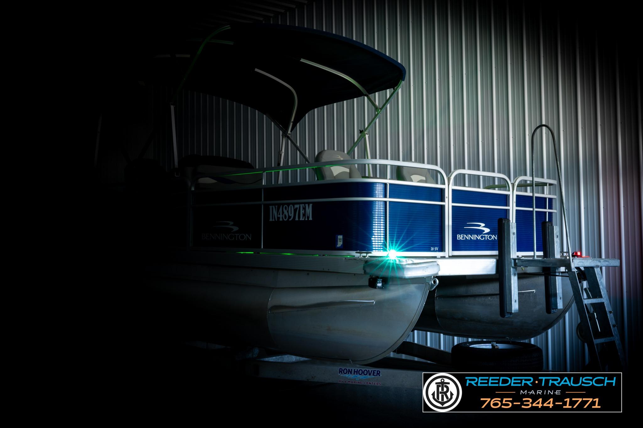 2021 Bennington 20 SV pontoon boat in a dimly lit storage area.