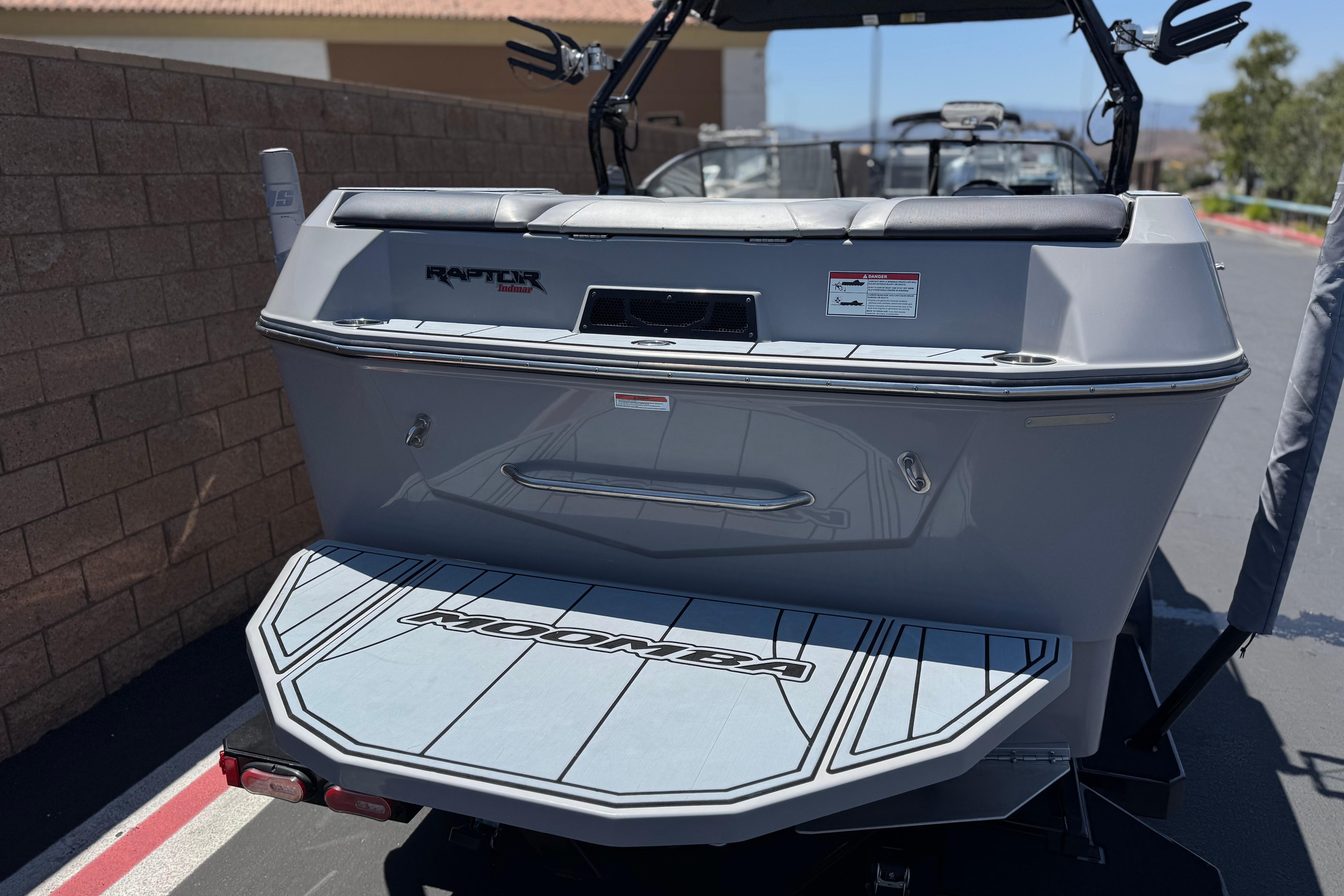 2022 Moomba Max boat rear view with Raptor engine branding, parked outdoors.