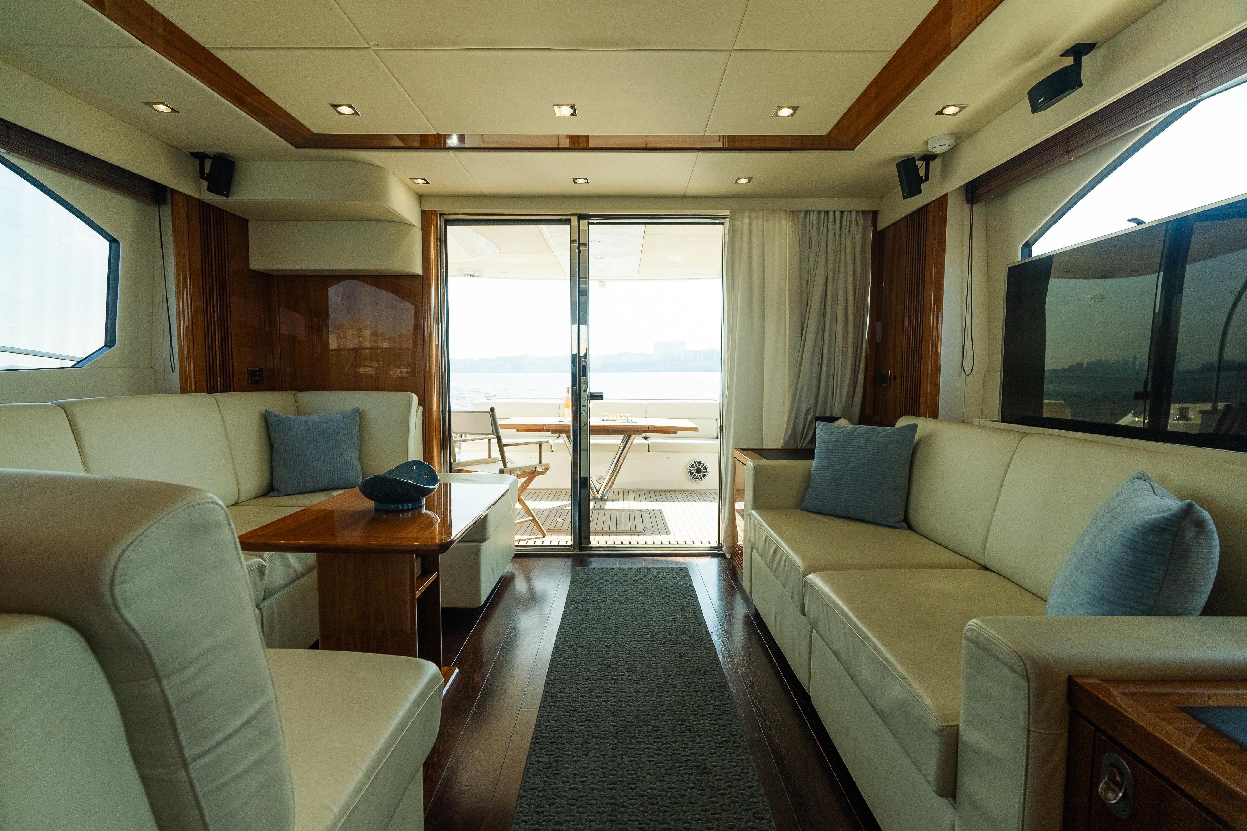 Luxurious interior of 2016 Sunseeker Manhattan 65 yacht with elegant seating and wood accents.
