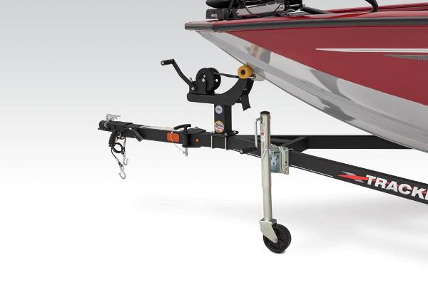 Close-up of a boat trailer with a red boat on it.