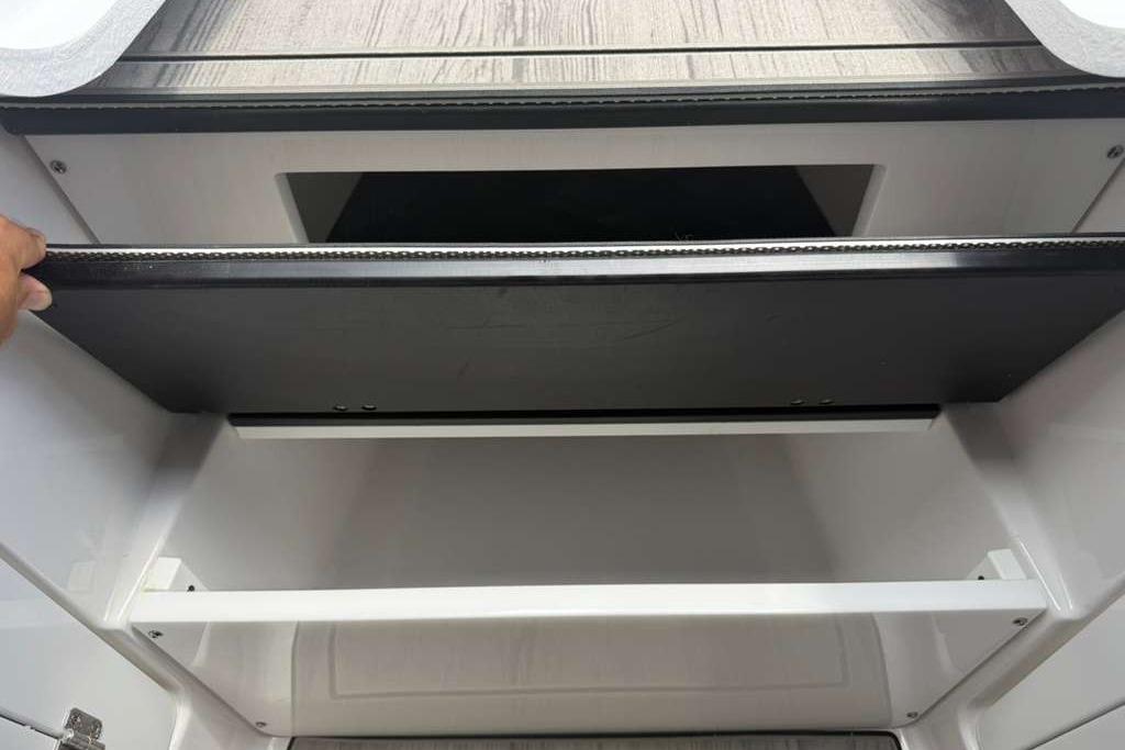Storage compartment in 2026 Monterey Elite 30 OB boat, featuring sleek design and ample space.