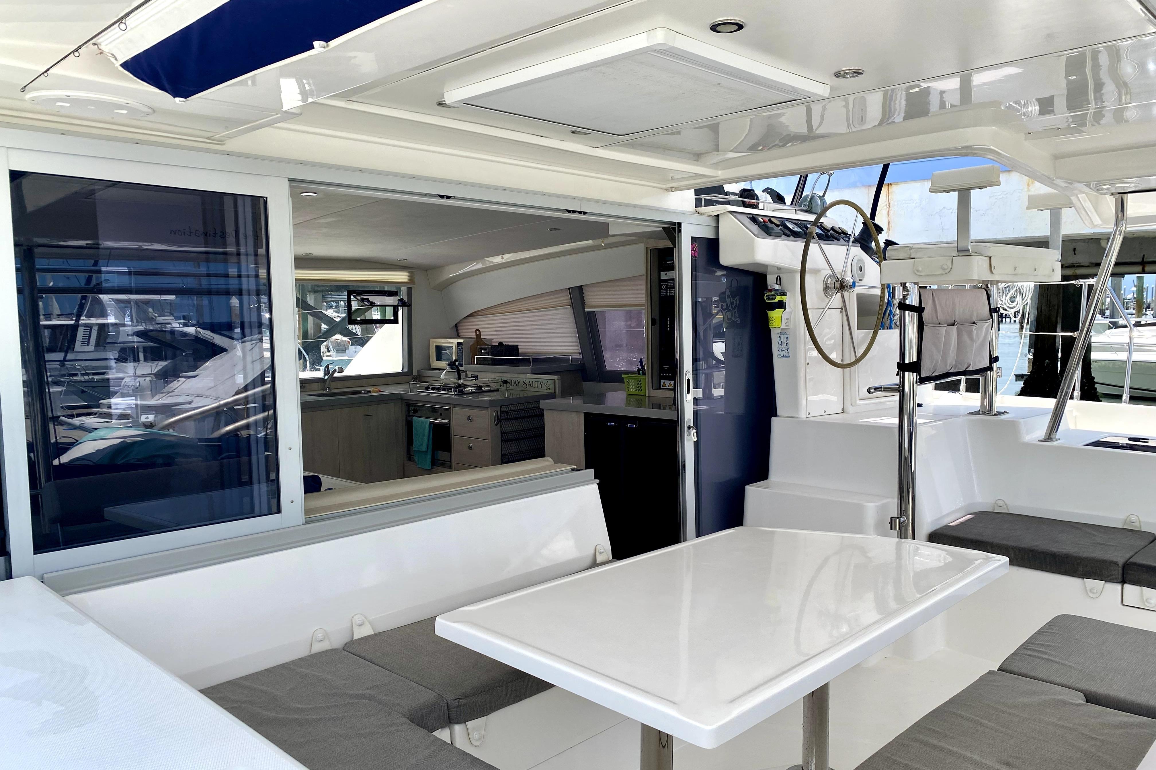 Interior view of a 2017 Leopard 40 catamaran, featuring a modern helm and dining area.