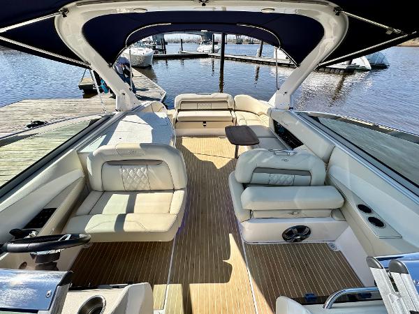 The image shows the interior of a 2018 Regal 3300 boat with sleek seating and wood flooring.