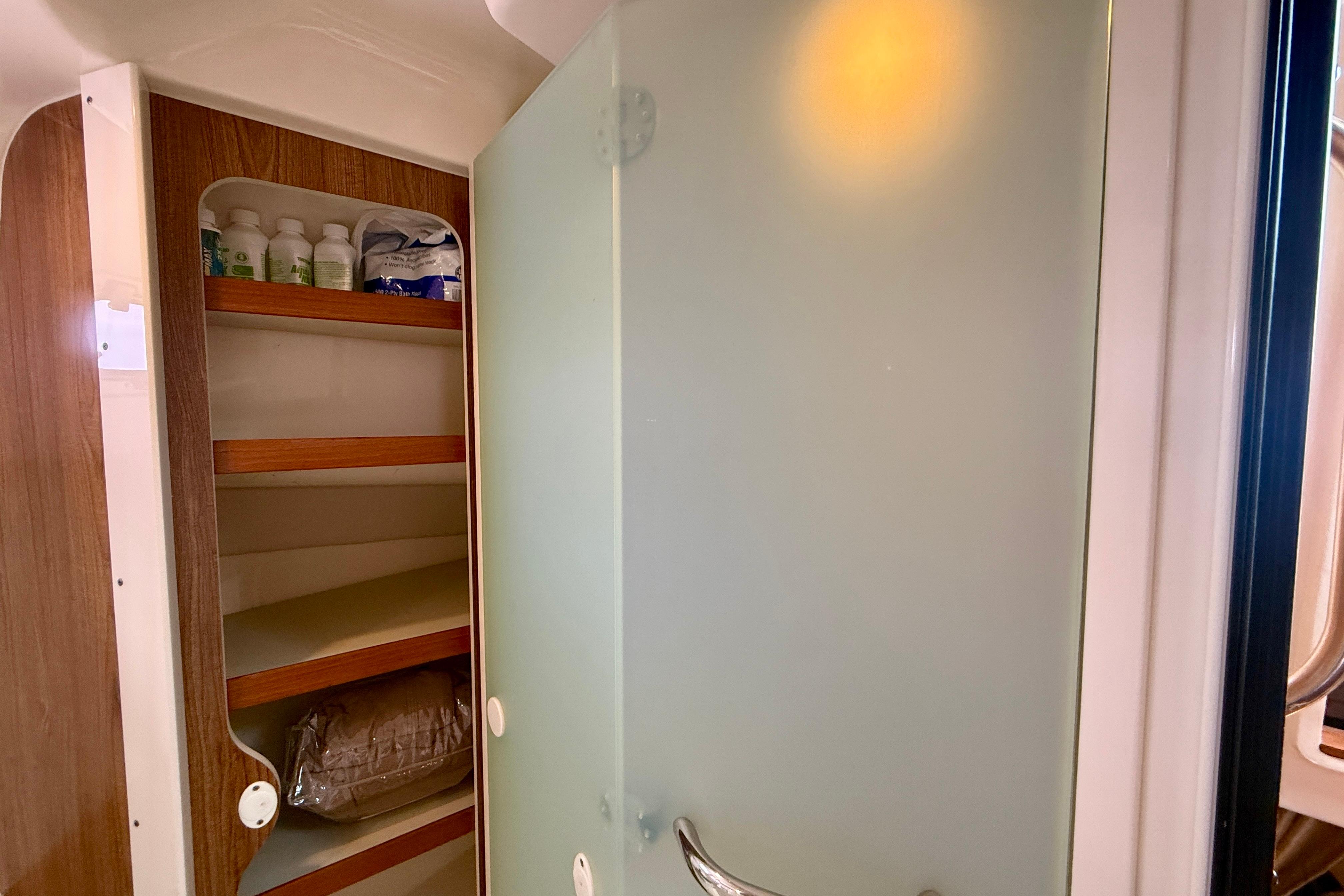 Interior of 2012 Pursuit OS 345 Offshore with storage shelves.