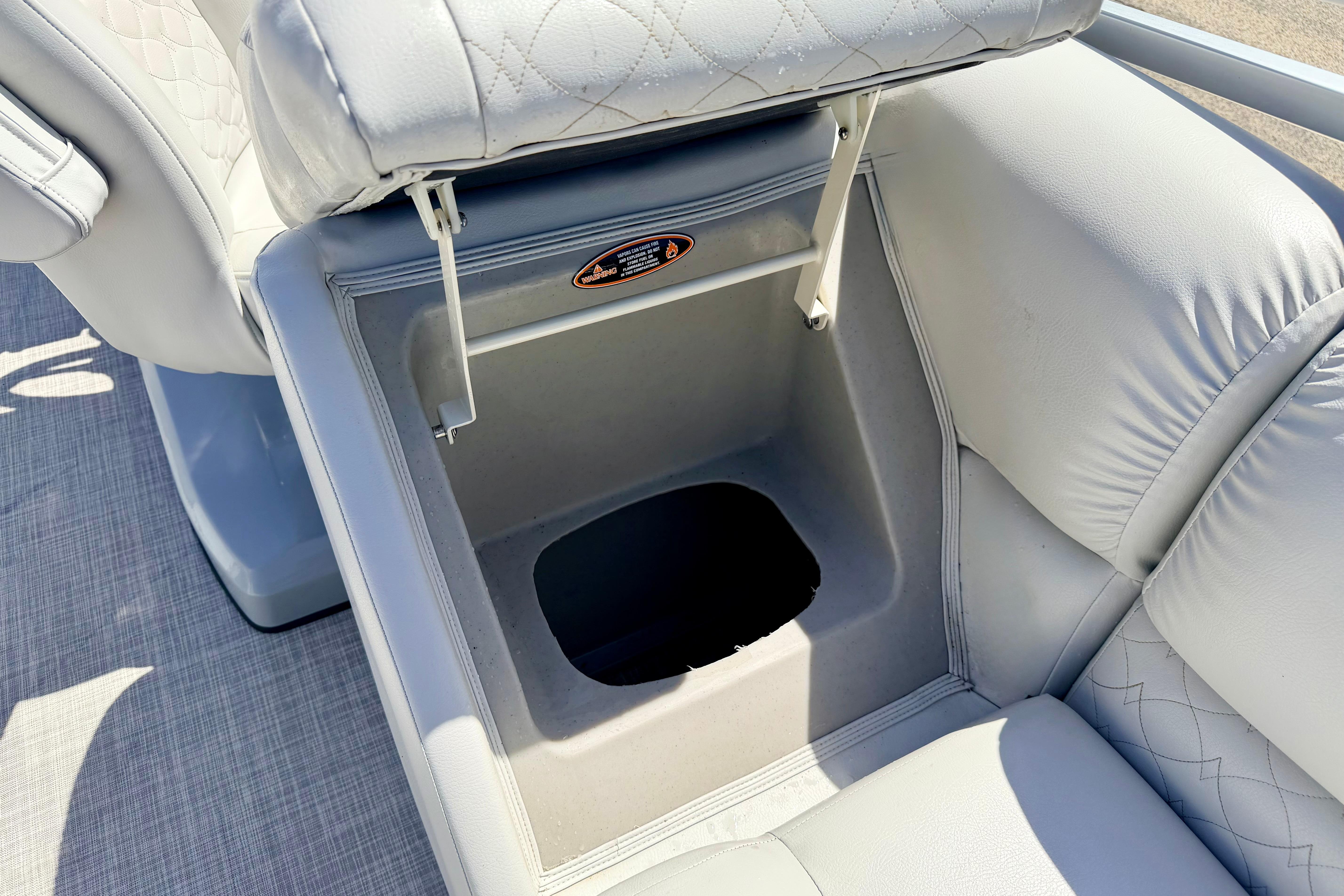 2019 Crestliner 240 Rally DX CW boat seat with storage compartment open.