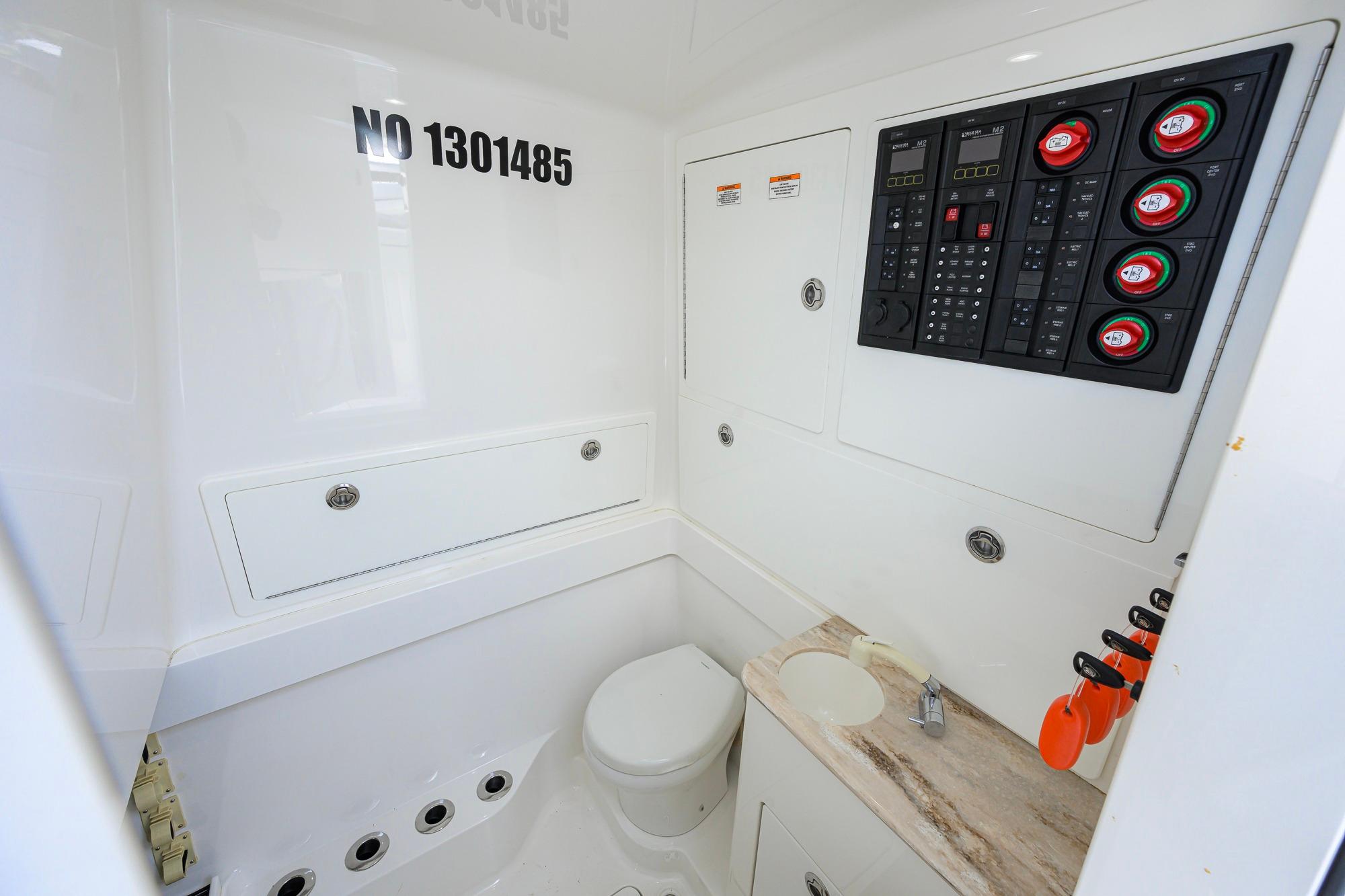 2020 Valhalla V-41 boat interior with control panel and compact bathroom.