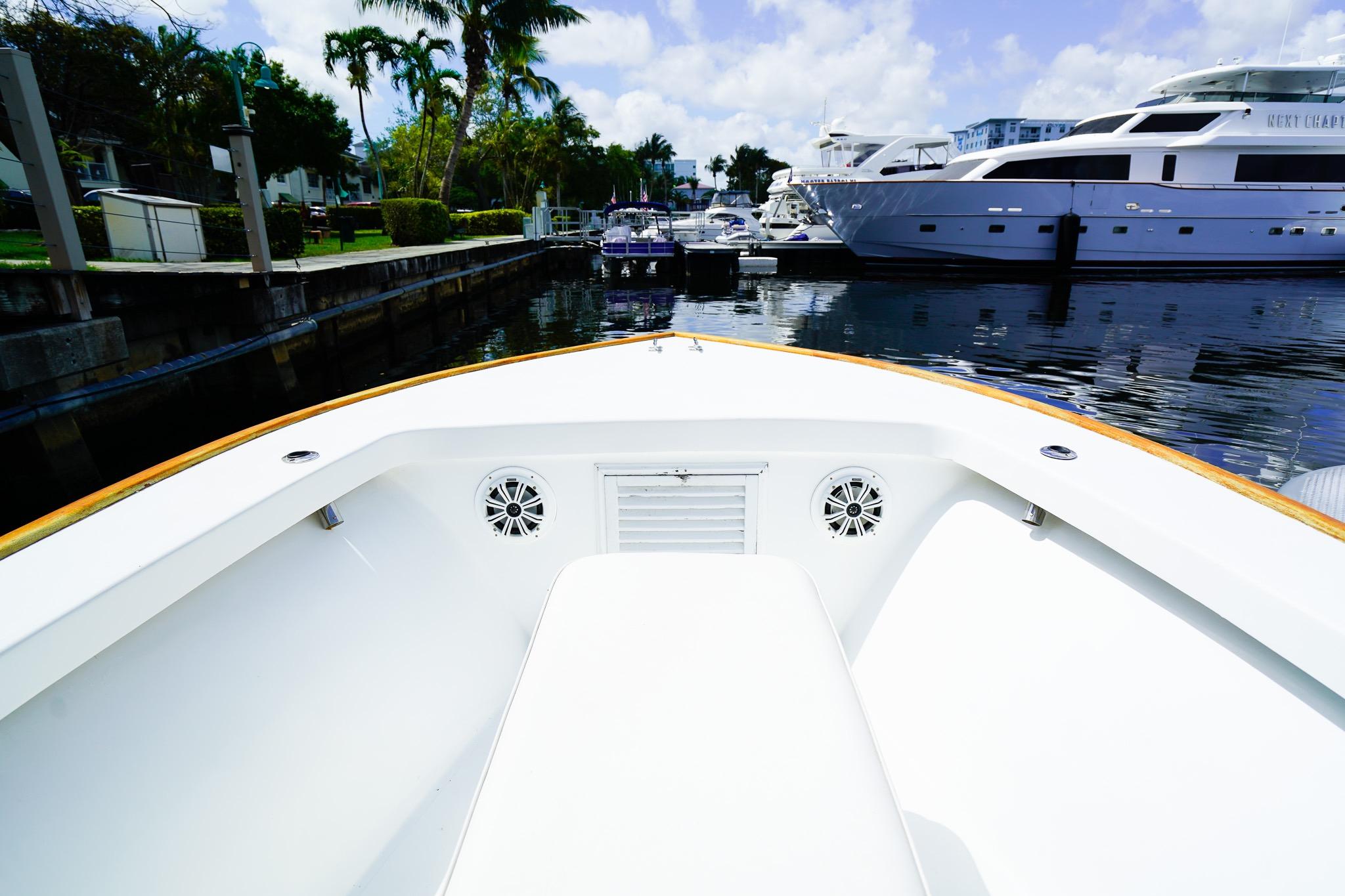 Bow view of a 1977 Scarborough 27 CC boat docked in a marina.