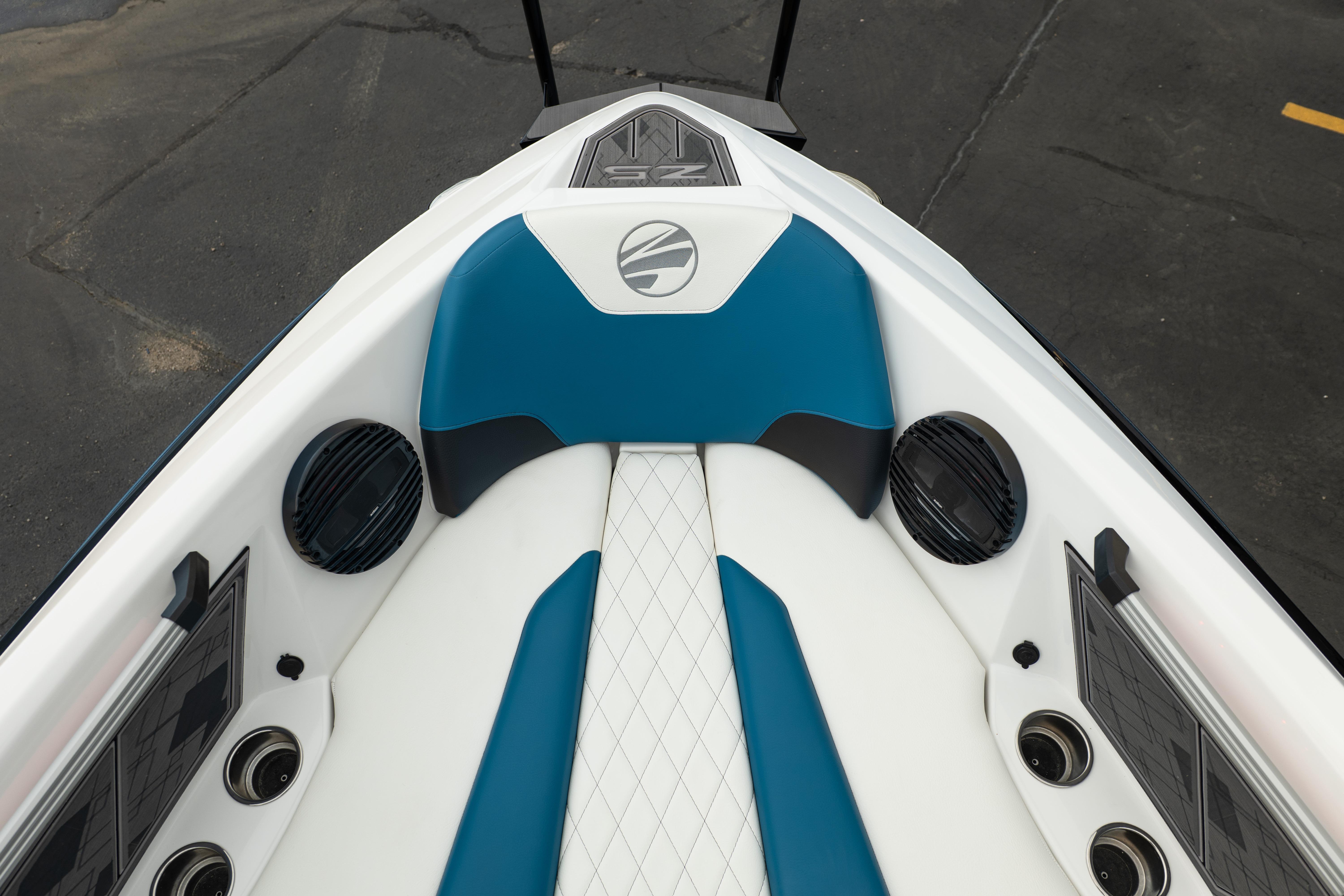 2024 Tigé Z5 boat interior with blue and white seating, speakers, and cup holders.