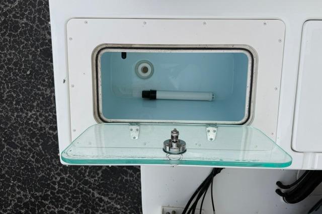 Open storage compartment on a 2016 Parker 2520 Sport Cabin boat.